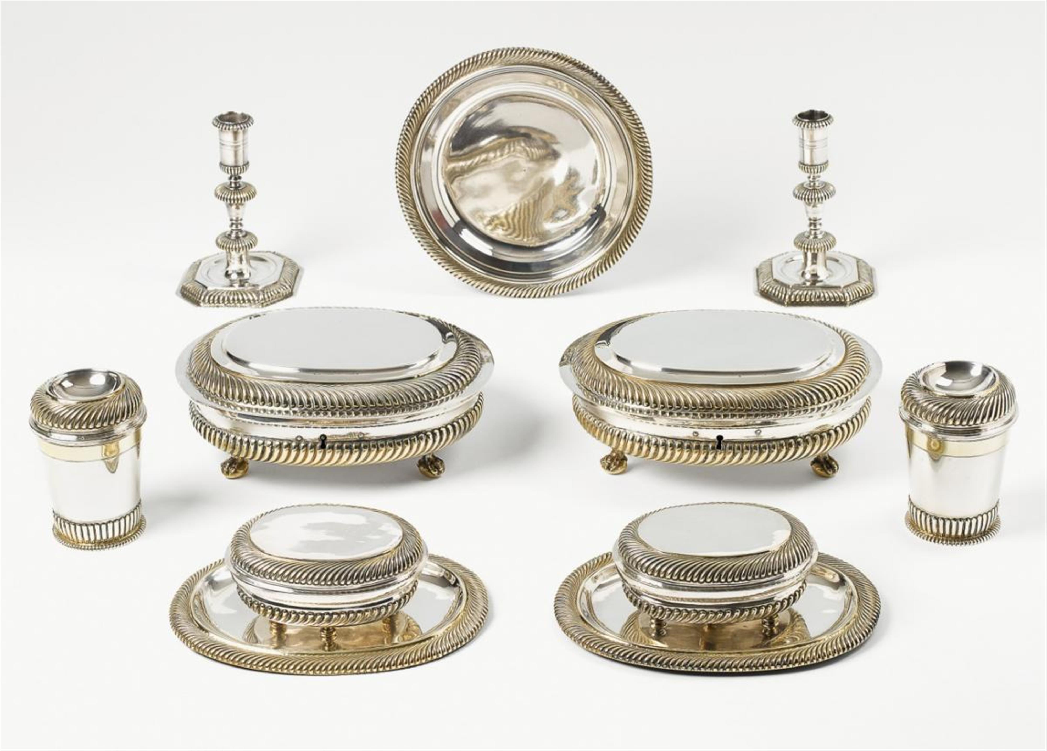 An Augsburg silver partially gilt travel service. Comprising two boxes with presentoires, two locking boxes (one with key), a pair of candlesticks, a pair of lidded beakers and a plate. Marks of Christian Winter and Georg Friebel, 1699 - 1703. - image-1