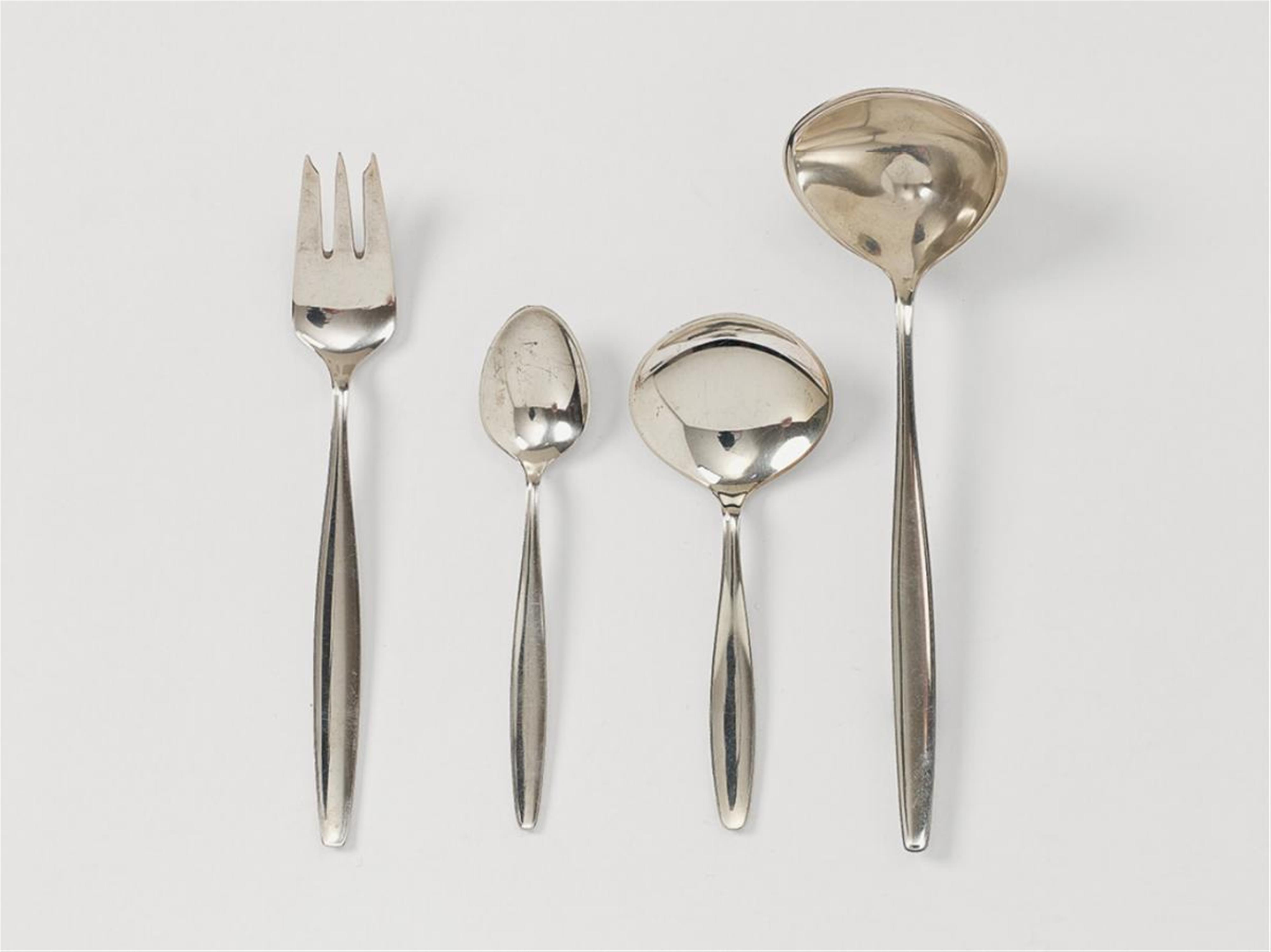 A silver Cypress pattern cutlery no. 99. Comprising six coffee spoons, six cake forks, sugar spoon and cream ladle. Design Tias Eckhoff 1954, made by Georg Jensen from 1954 - 76. - image-1
