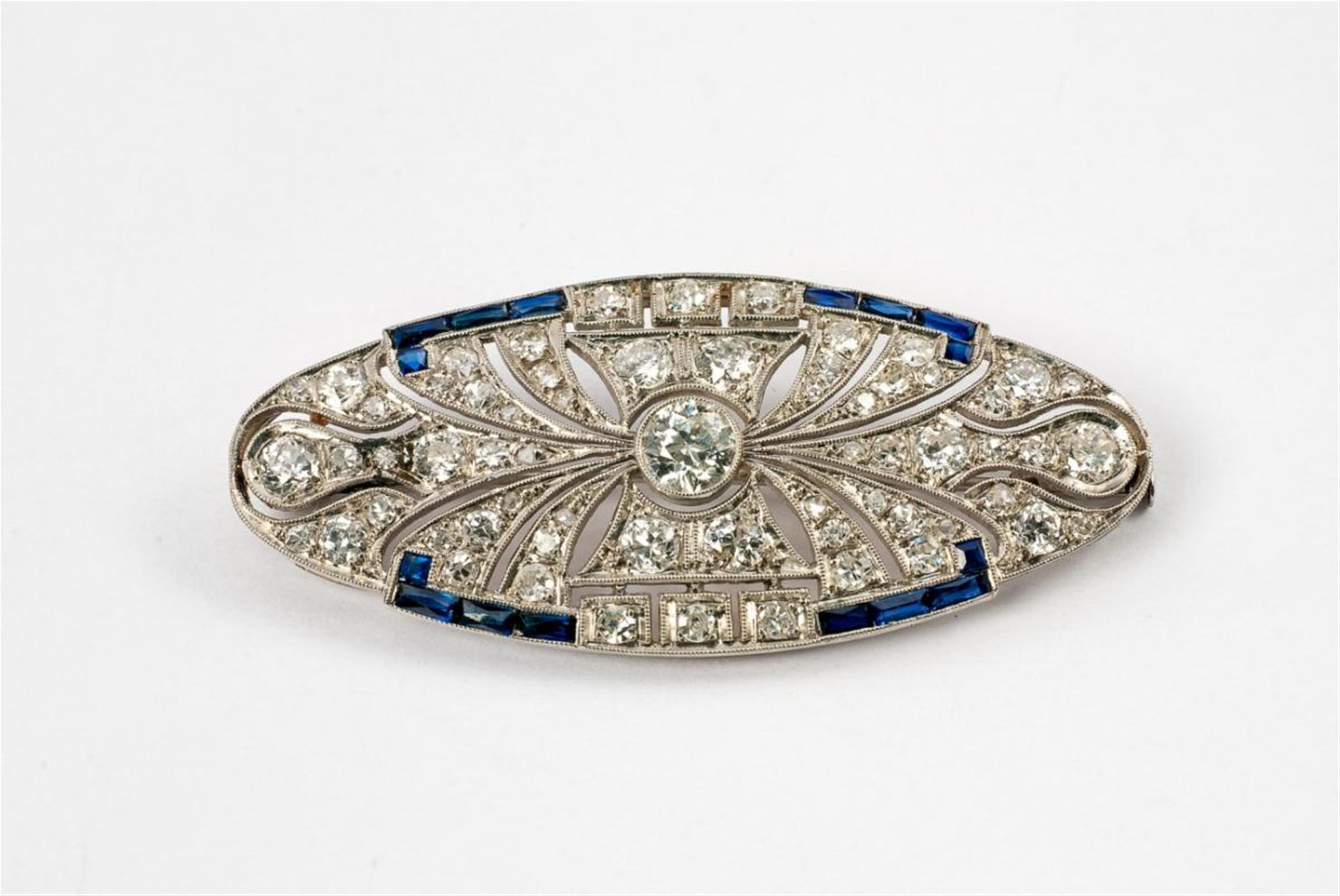 An Art Déco platinum, diamond and sapphire brooch - image-1