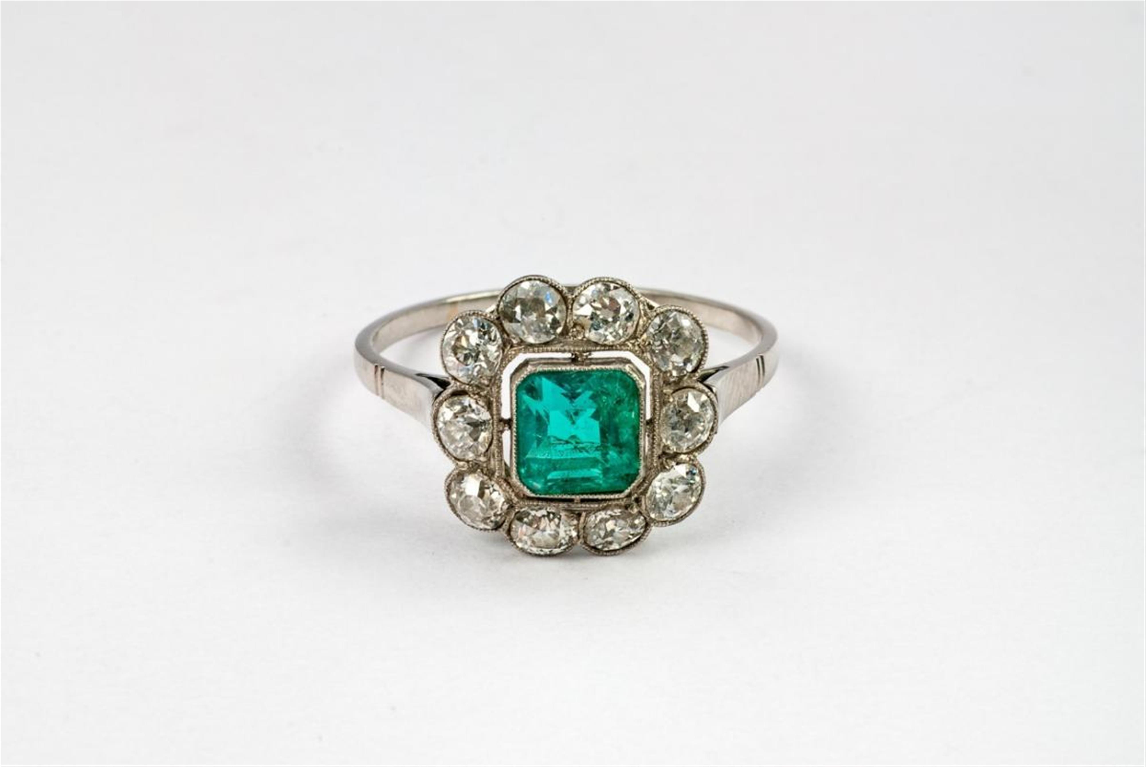 An Art Déco platinum, diamond and emerald cluster ring. - image-1