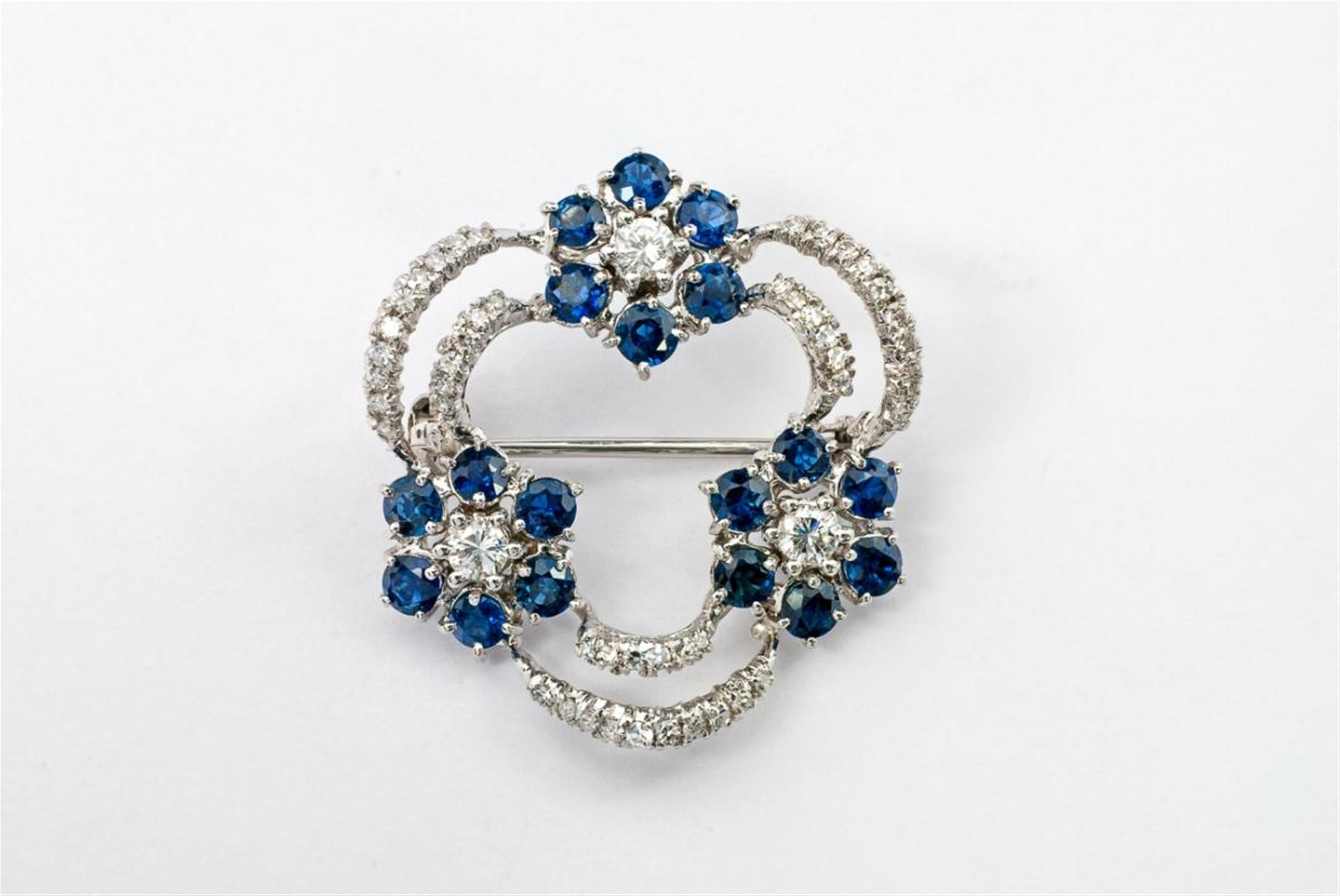 A small 18 ct white gold, diamond and sapphire wreath-form brooch. - image-1