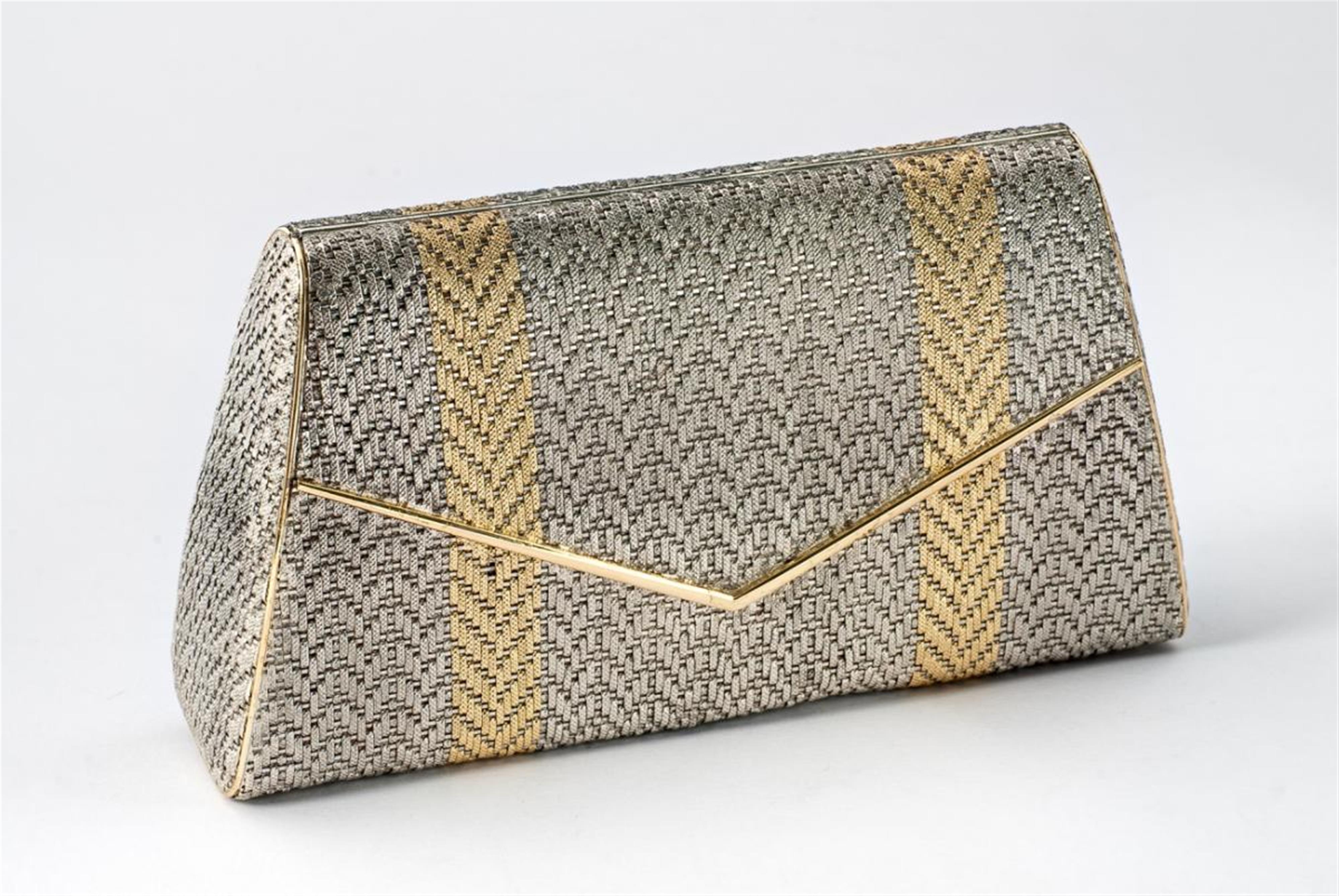 A small partially gilt silver clutch bag with gold mounted edges - image-1