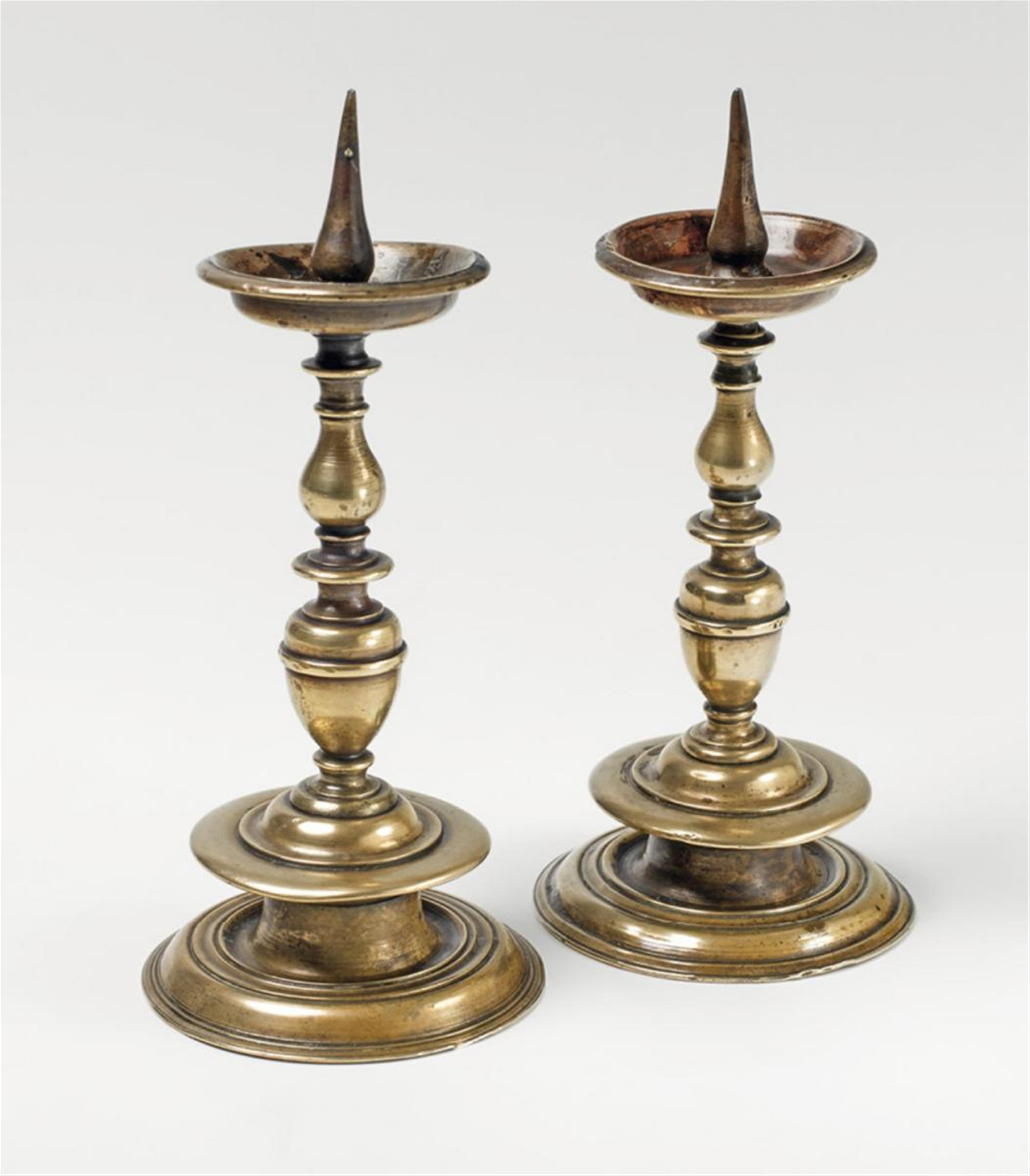 A pair of small South German brass altar candlesticks - image-1