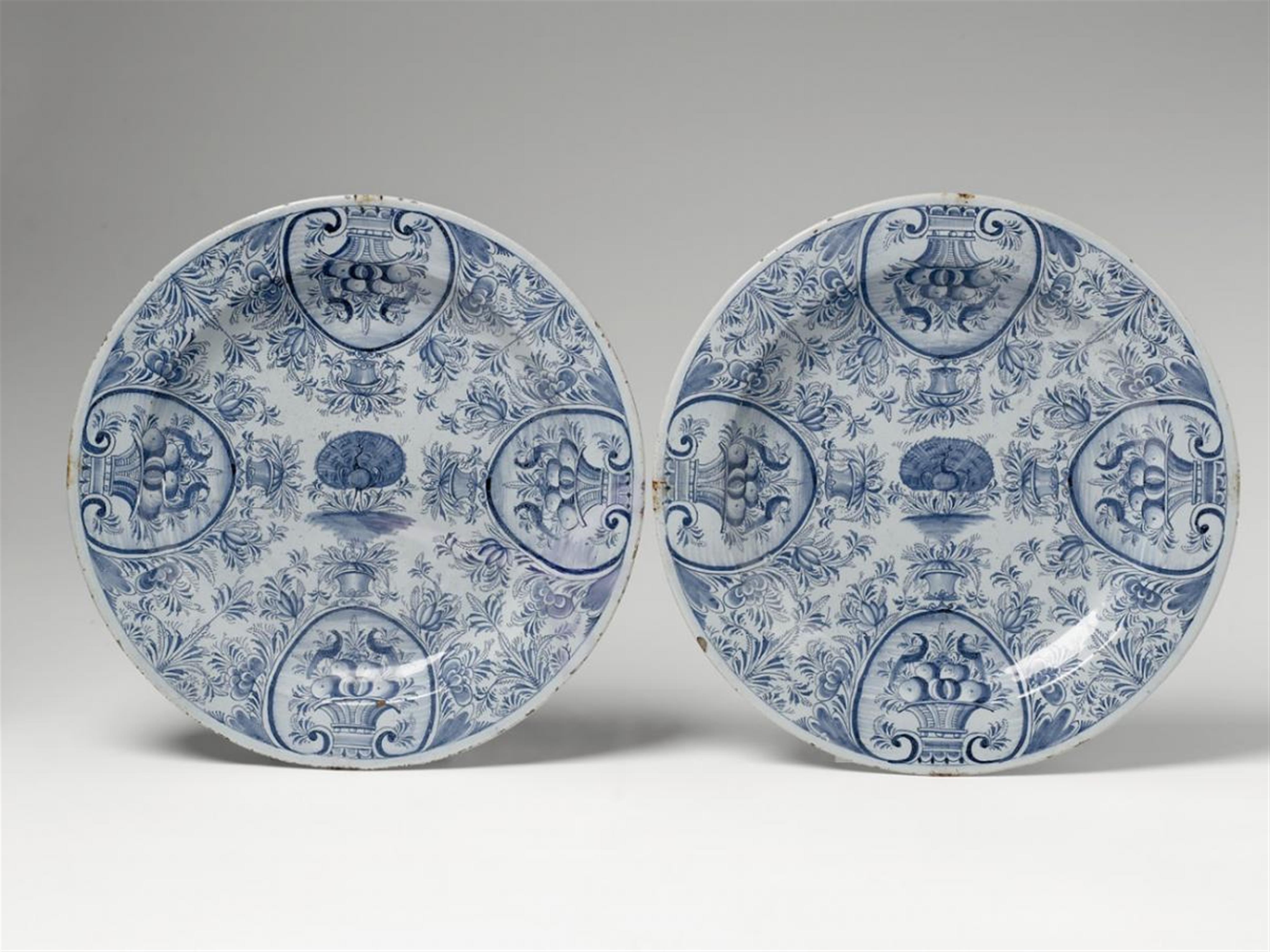 A pair of Nuremberg faience platters with blue peacock decor above powder blue glaze. - image-1