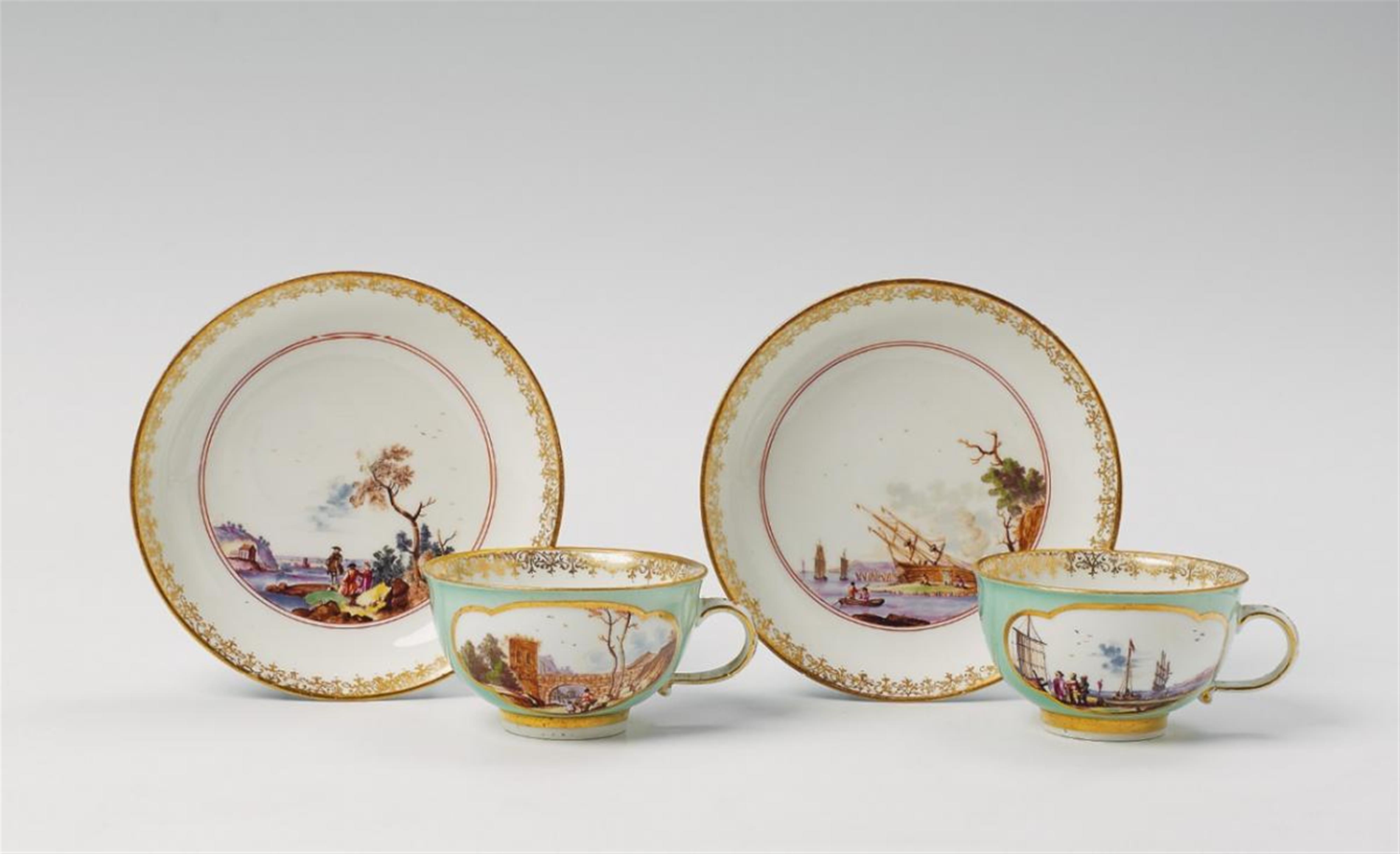 Apair of turquoise ground Meissen cups and saucers, the reserves painted with European landscapes. - image-2