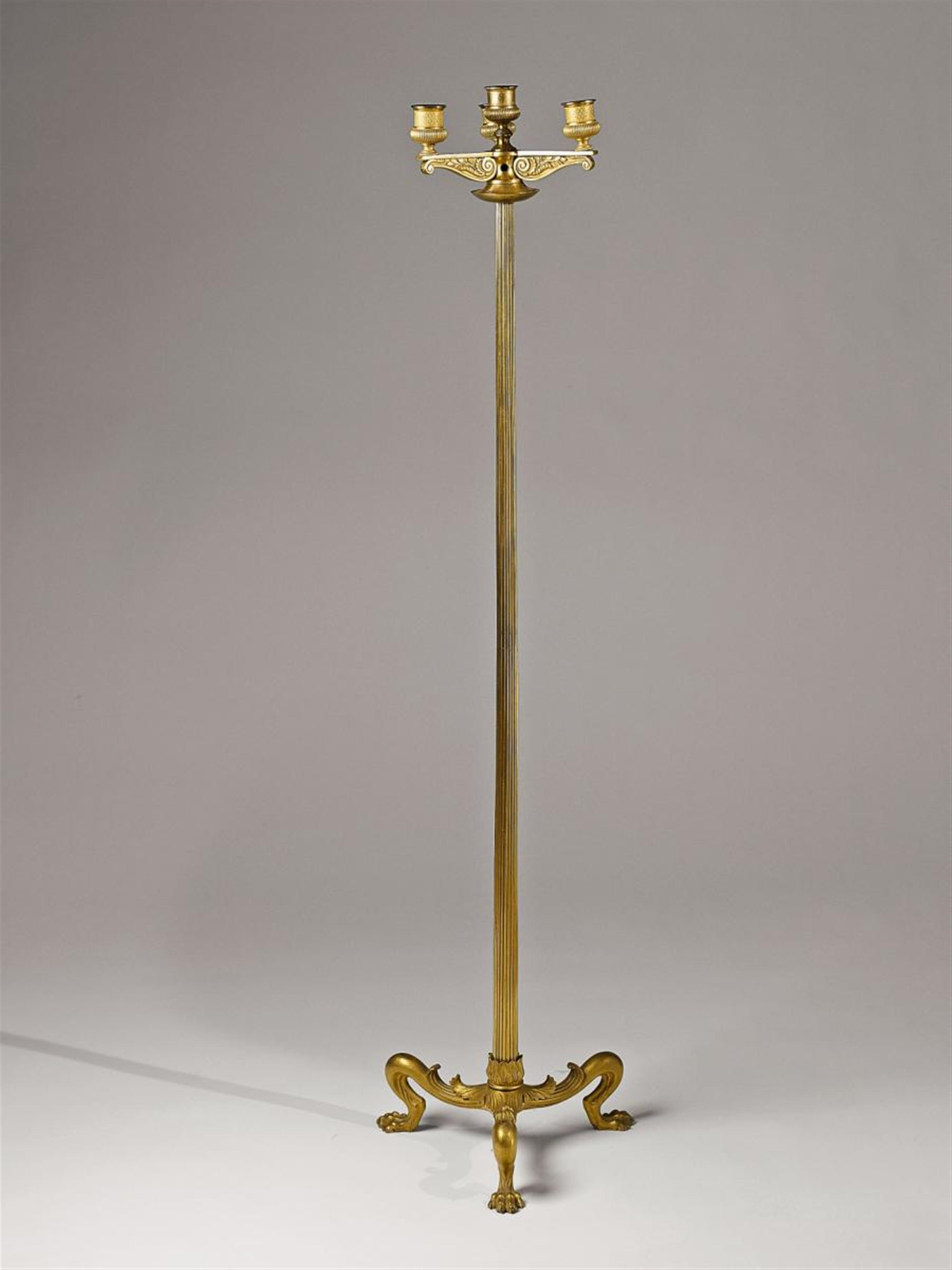 A fire-gilt bronze tripod candelabrum - image-1
