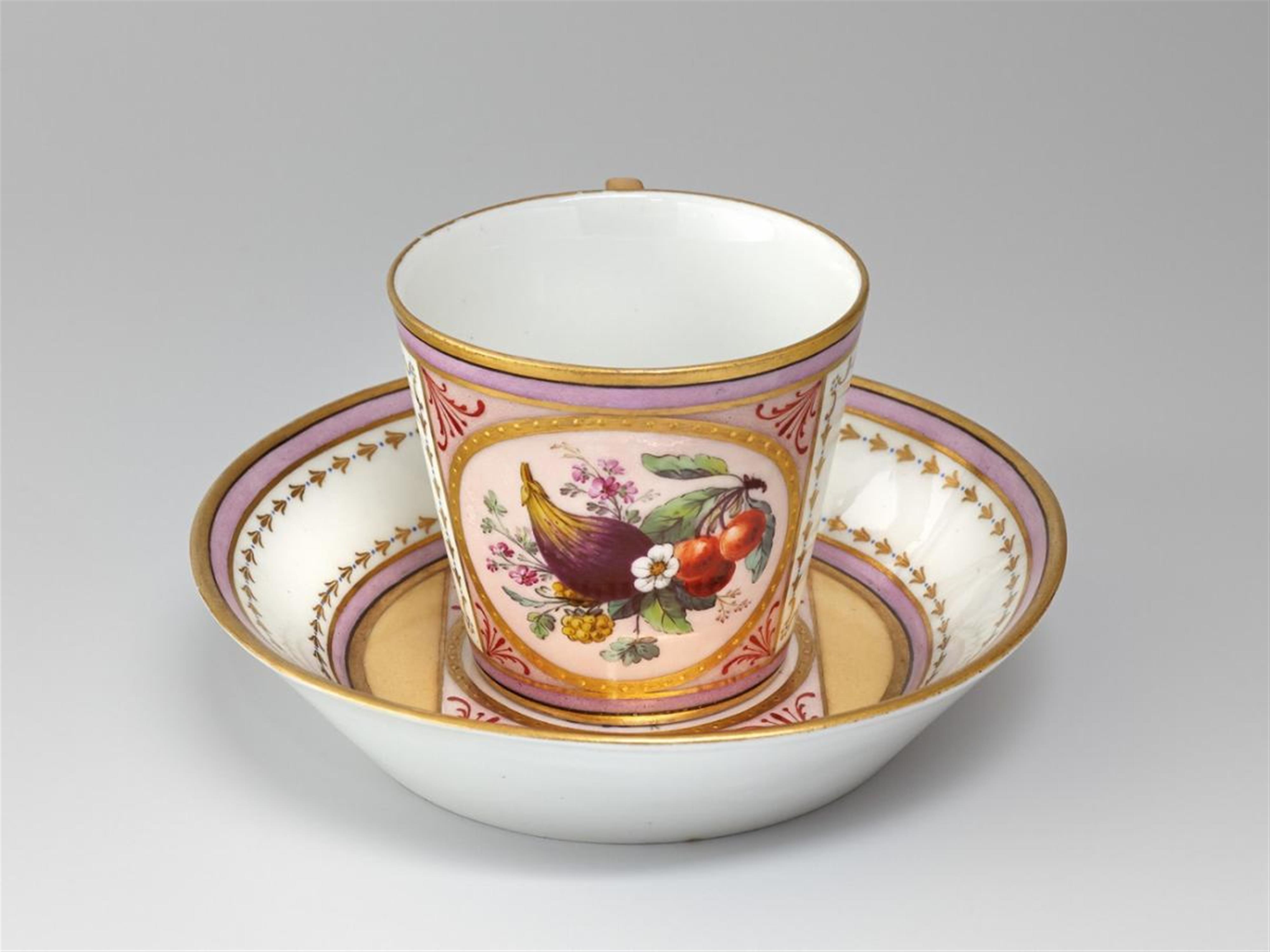A KPM cup and saucer with fruit decor. - image-1