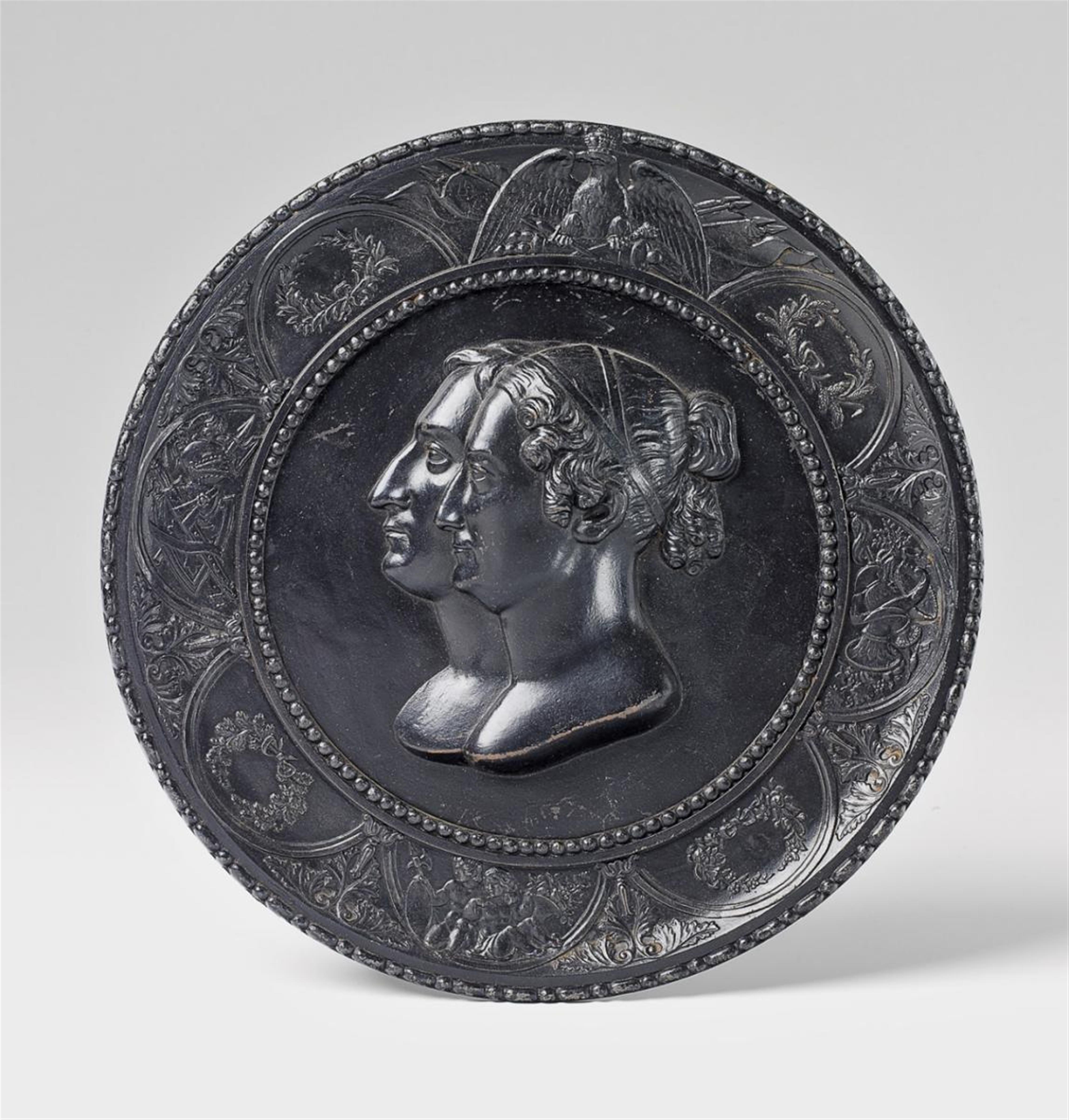 A black patinated cast iron tondo with a royal double portrait. - image-1