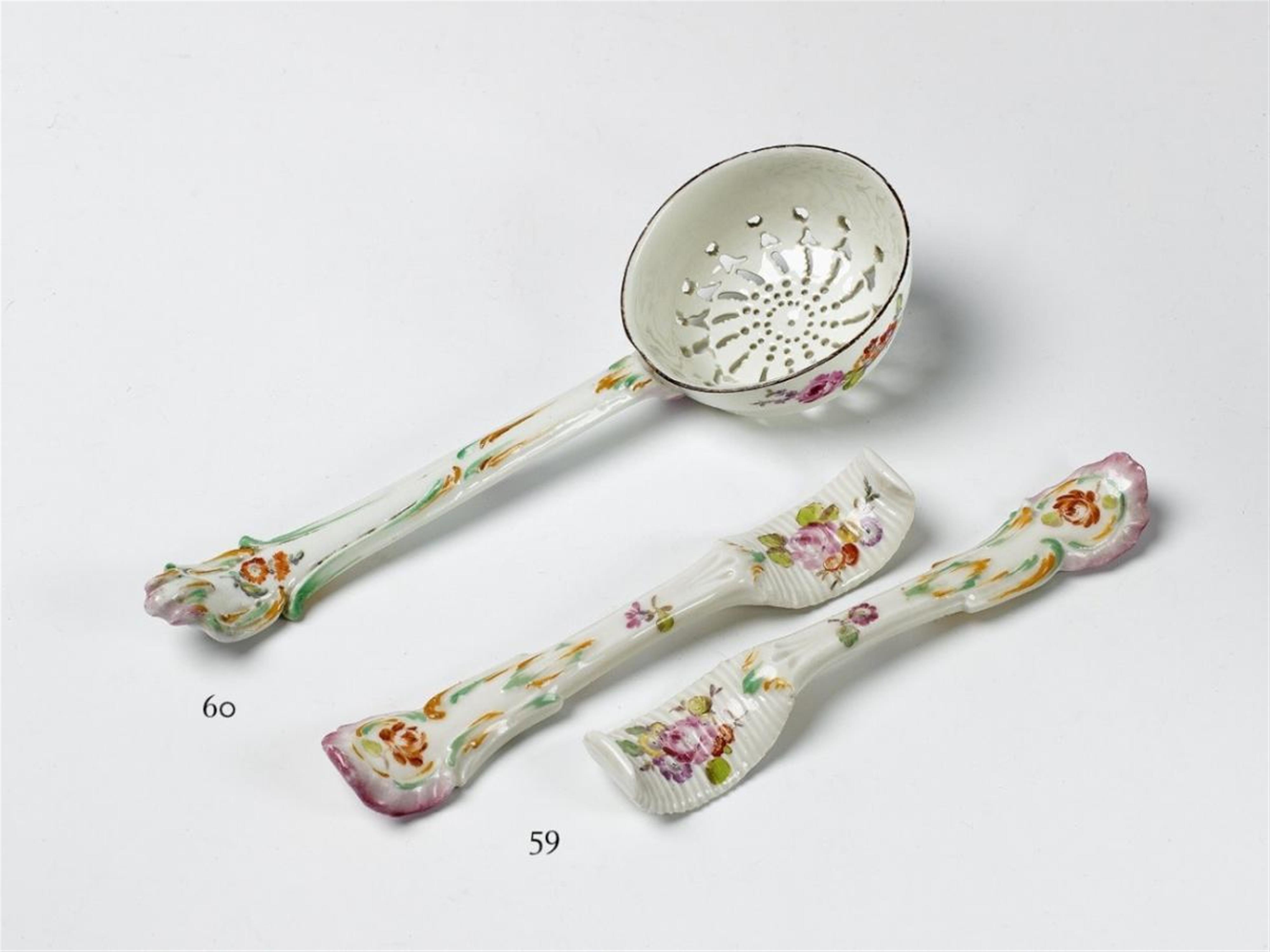 A KPM porcelain sugar spoon with floral decor. - image-1