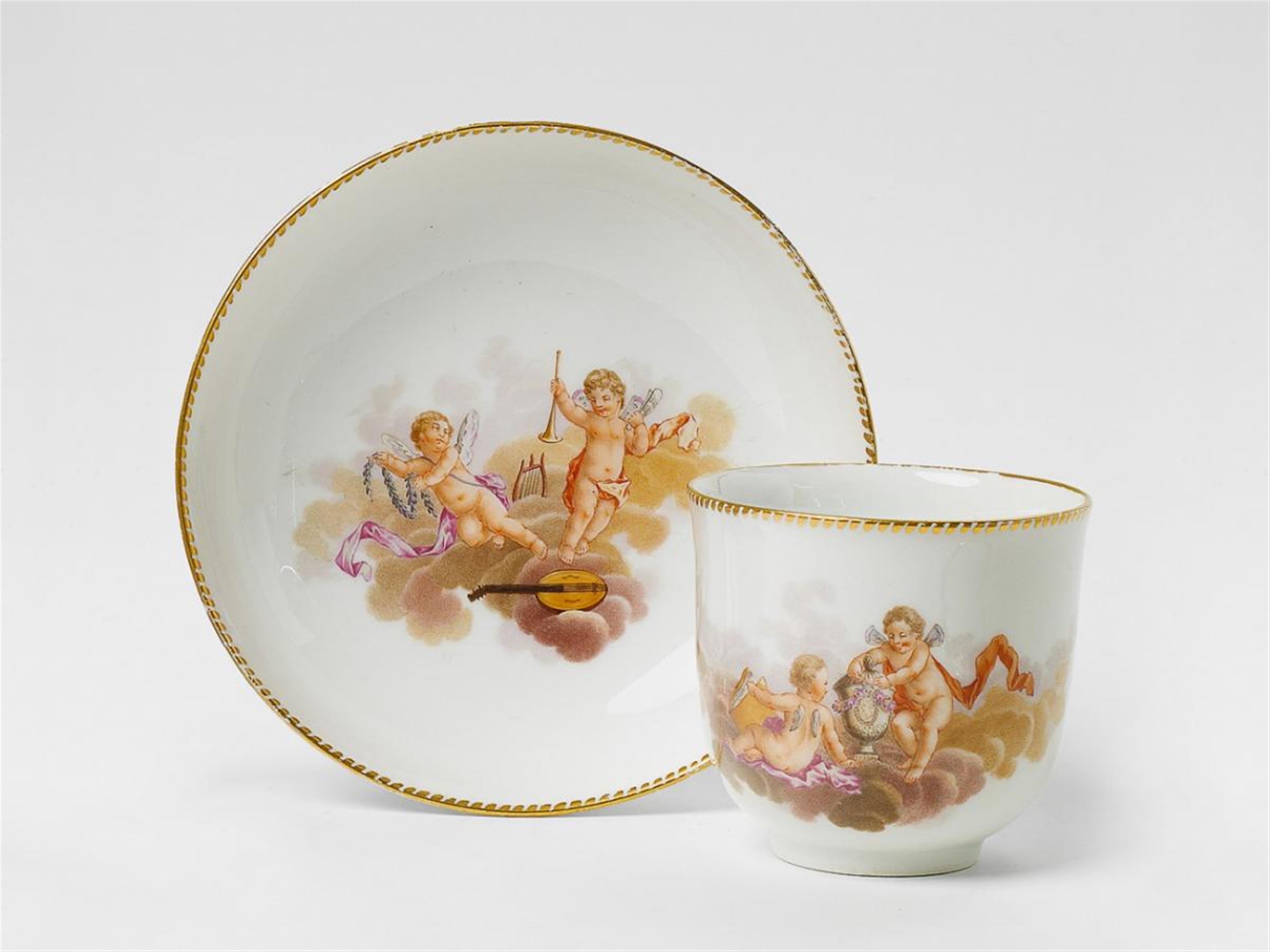 A KPM porcelain coffee cup with putti on clouds. - image-1