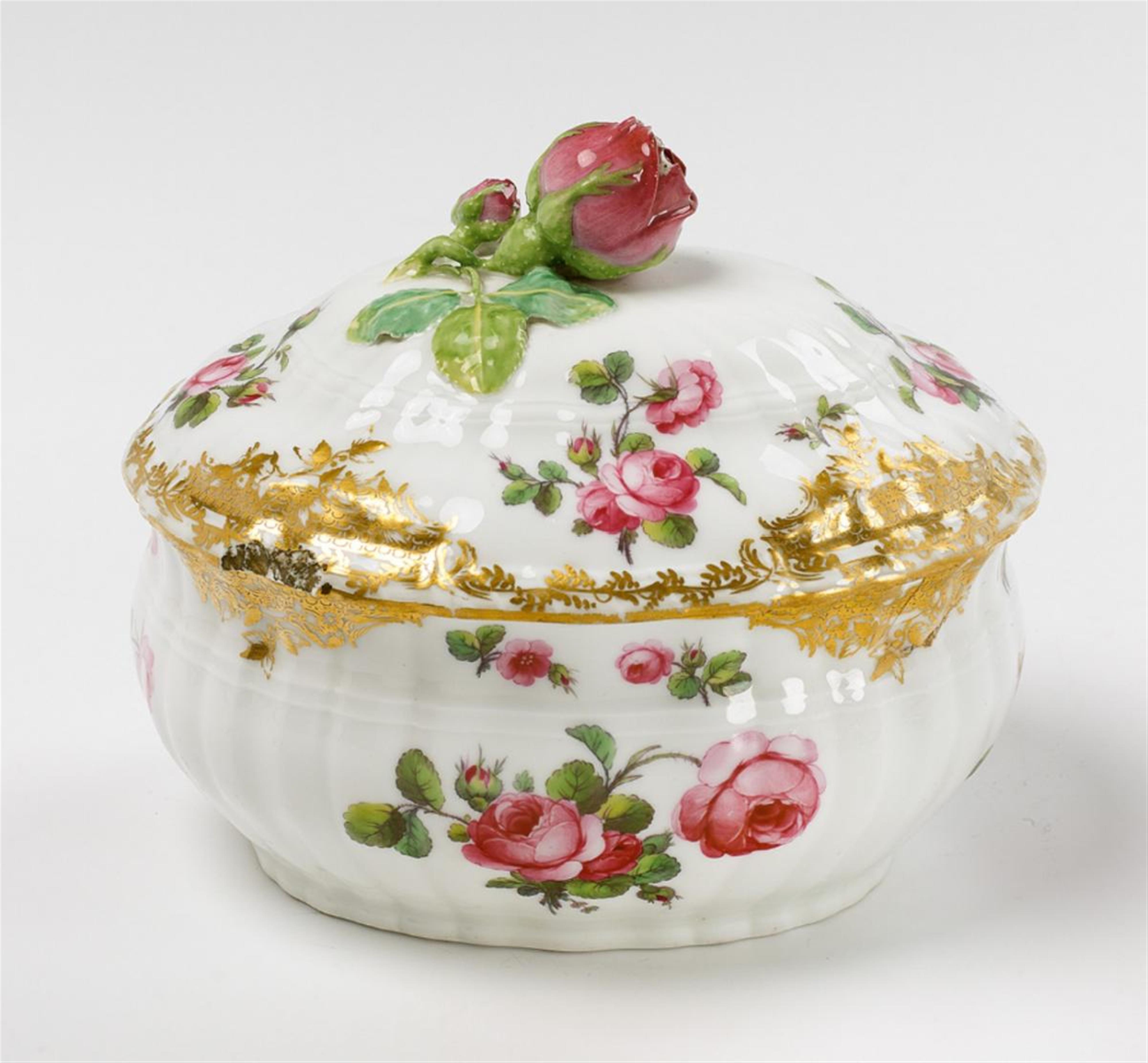 An oval KPM porcelain box and cover with a rose finial. - image-1