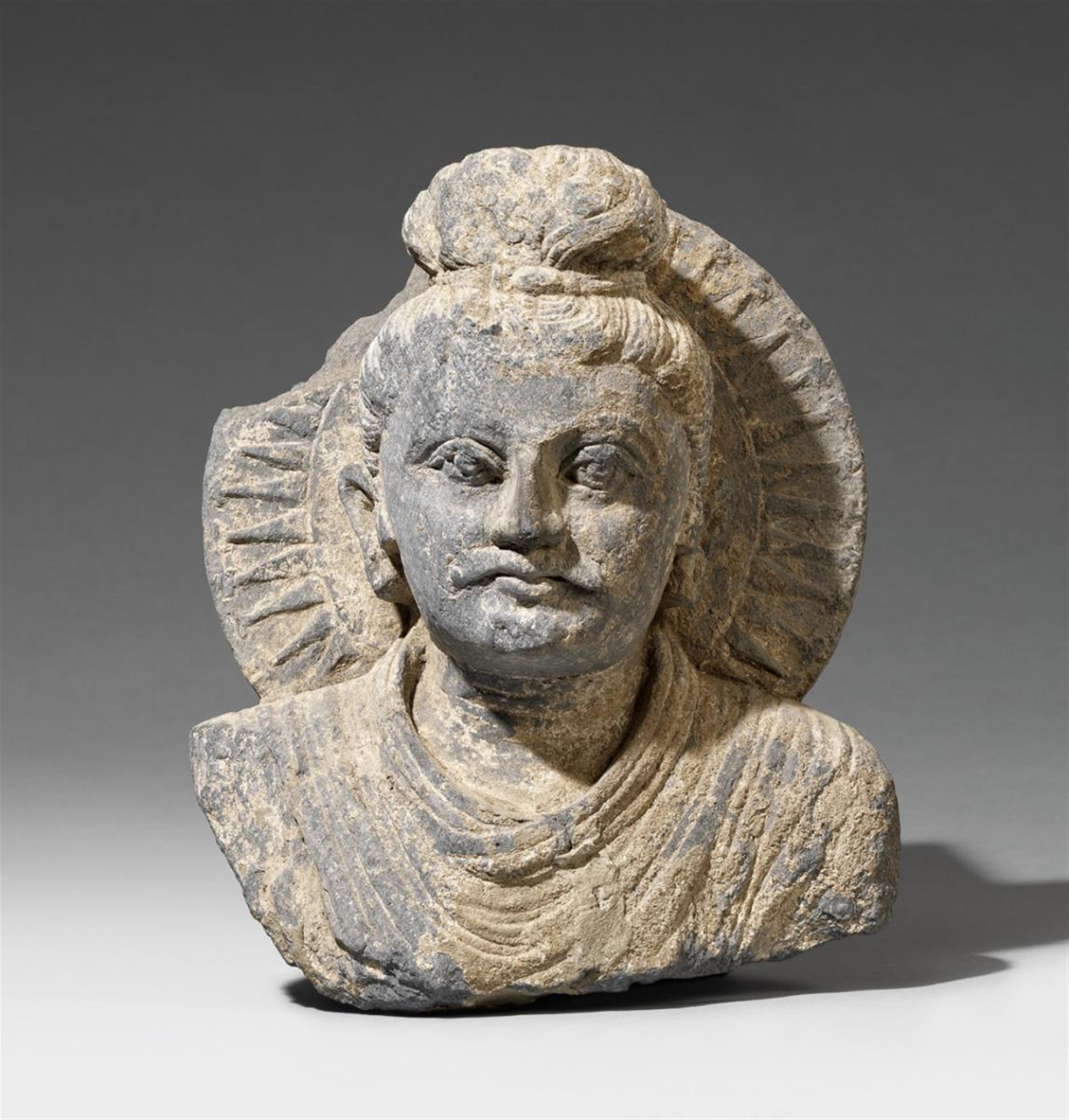 A Gandhara grey schist bust of a Buddha. 2nd/3rd century - image-1