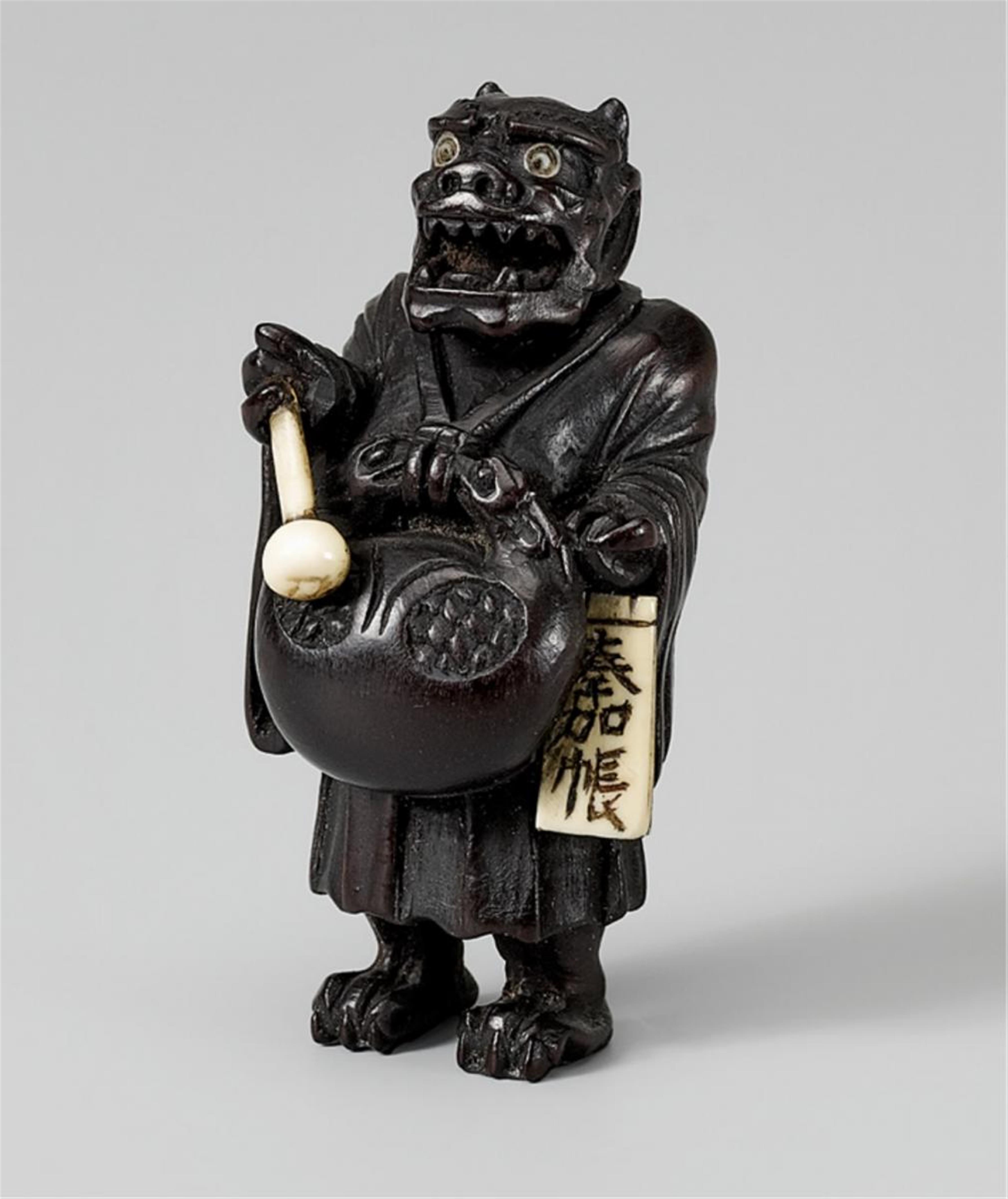 A dark wood netsuke of oni nenbutsu. Late 19th century - image-1