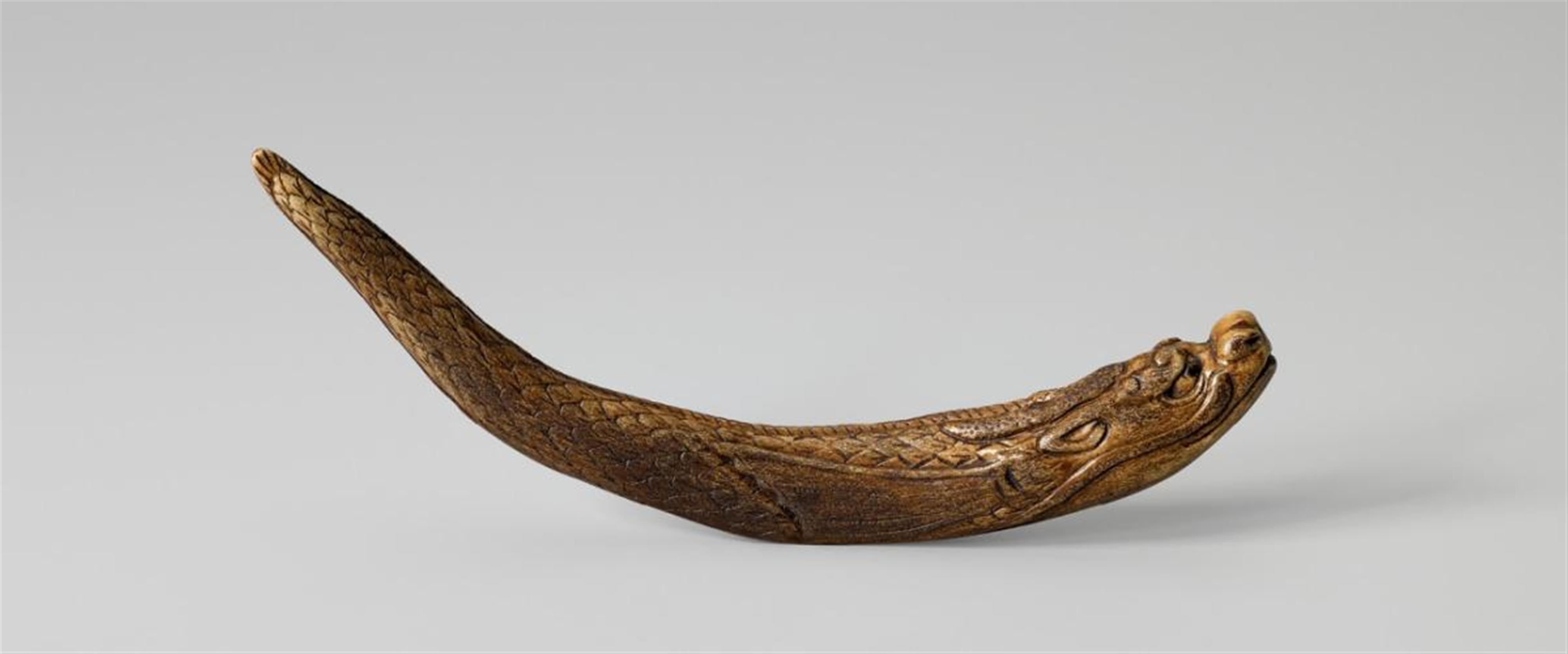 A stag antler netsuke of a dragon fish. - image-1