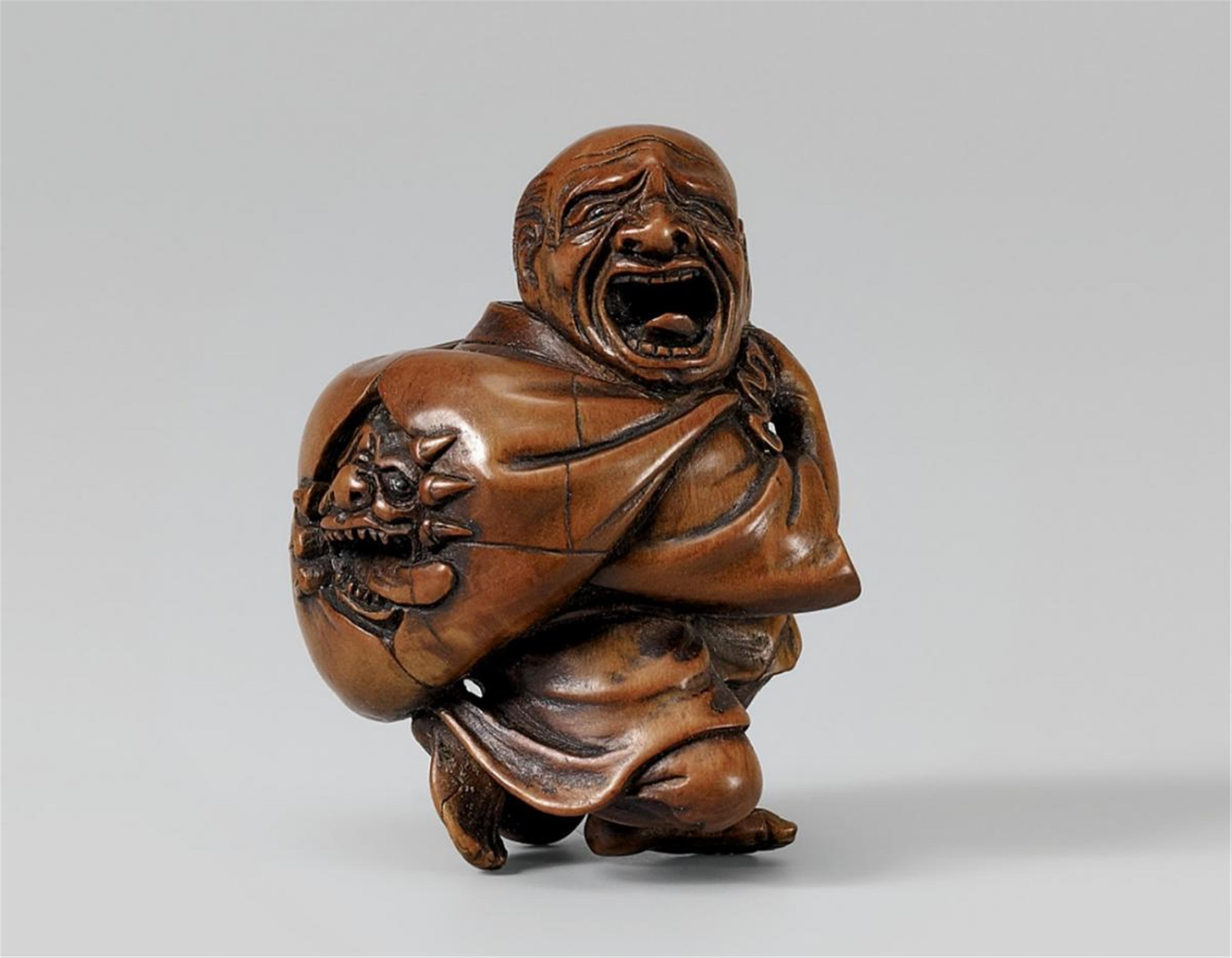 A large boxwood netsuke of a peasant with an oni in a sack. Mid 19th century - image-1