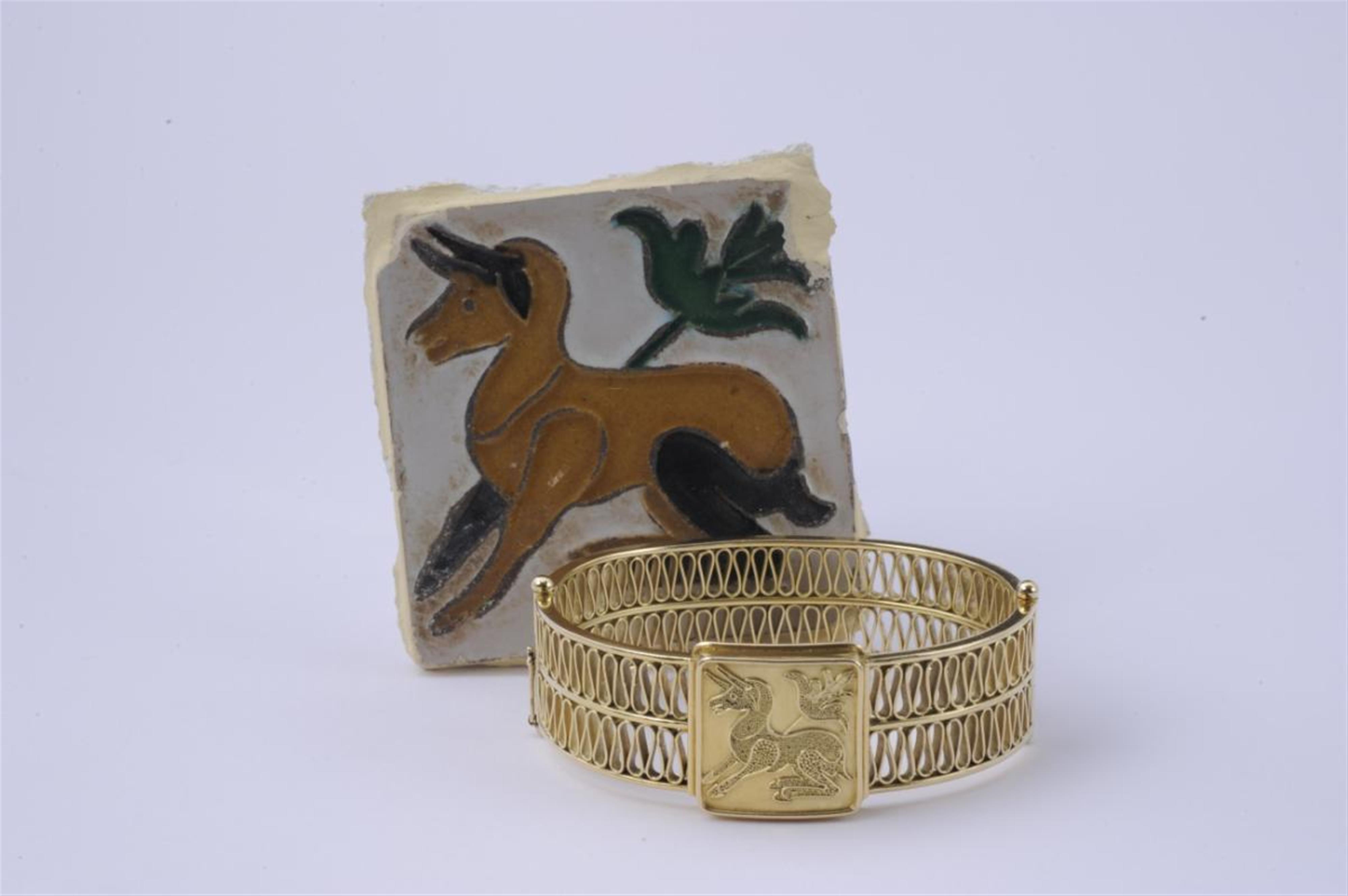 An 18k granulated gold bracelet with a depiction of a seated antilope. - image-1