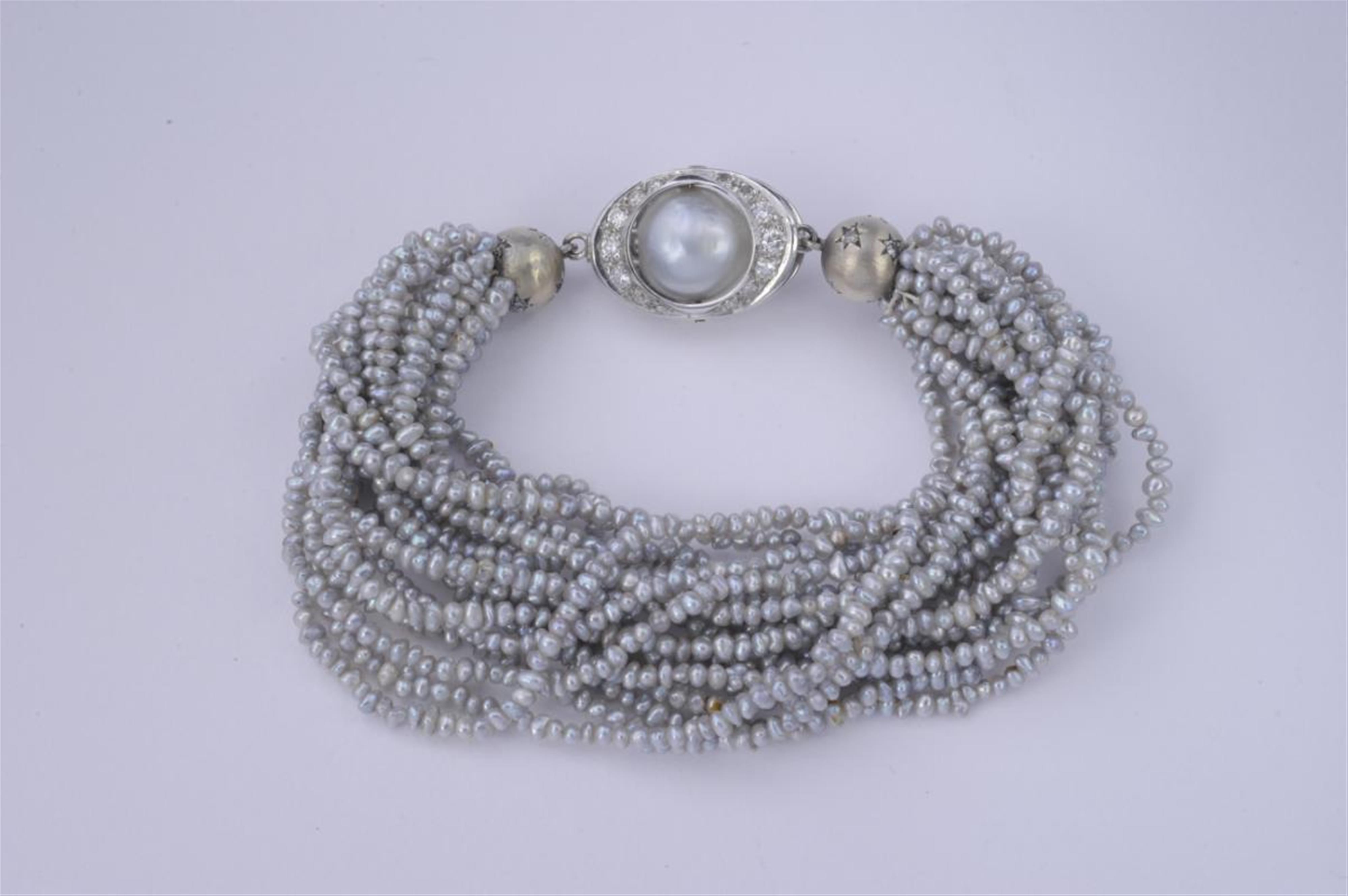 An 18k white gold and pearl bracelet. - image-1