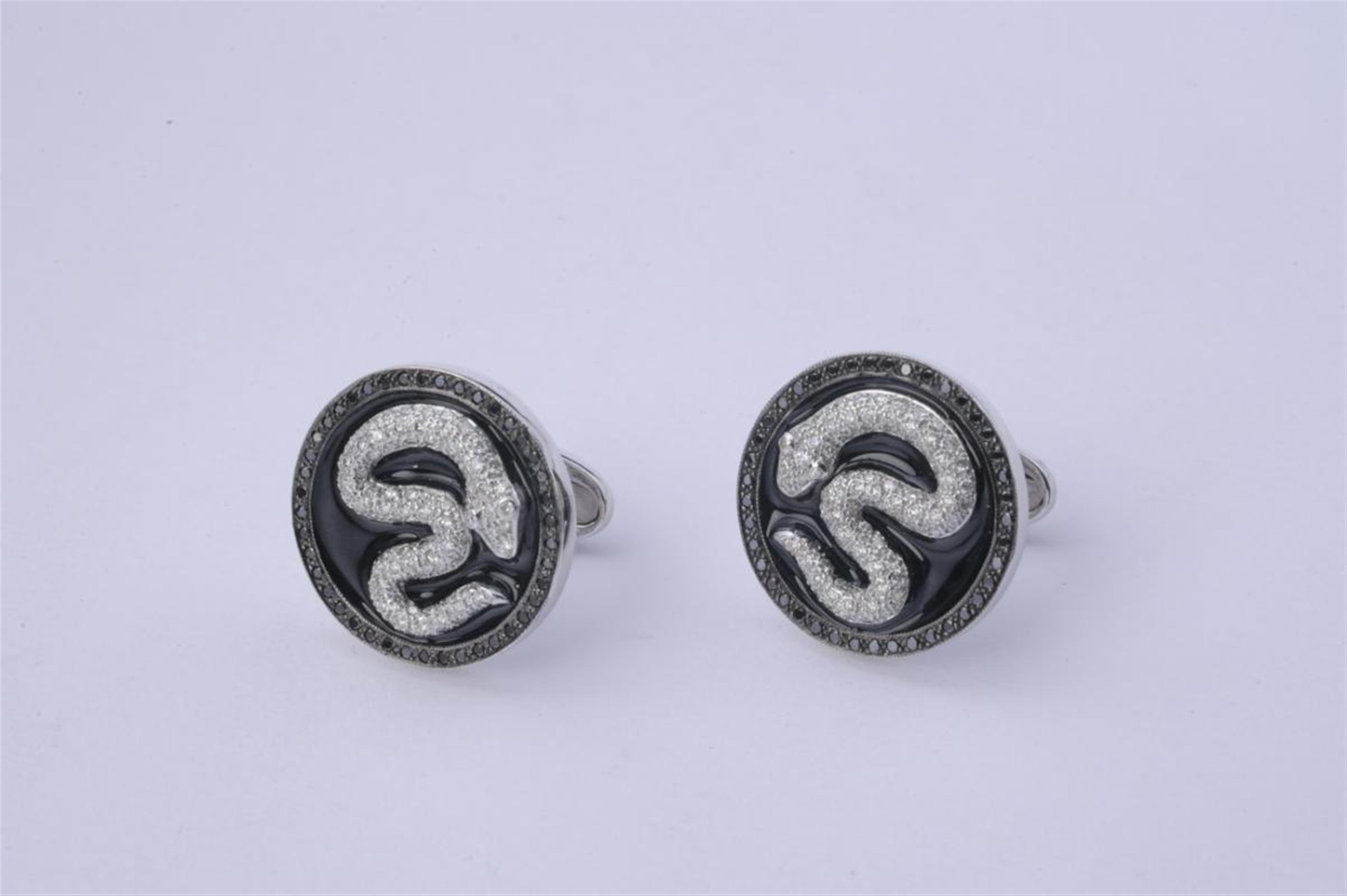 A pair of 14k white gold cufflinks formed as snakes. - image-1