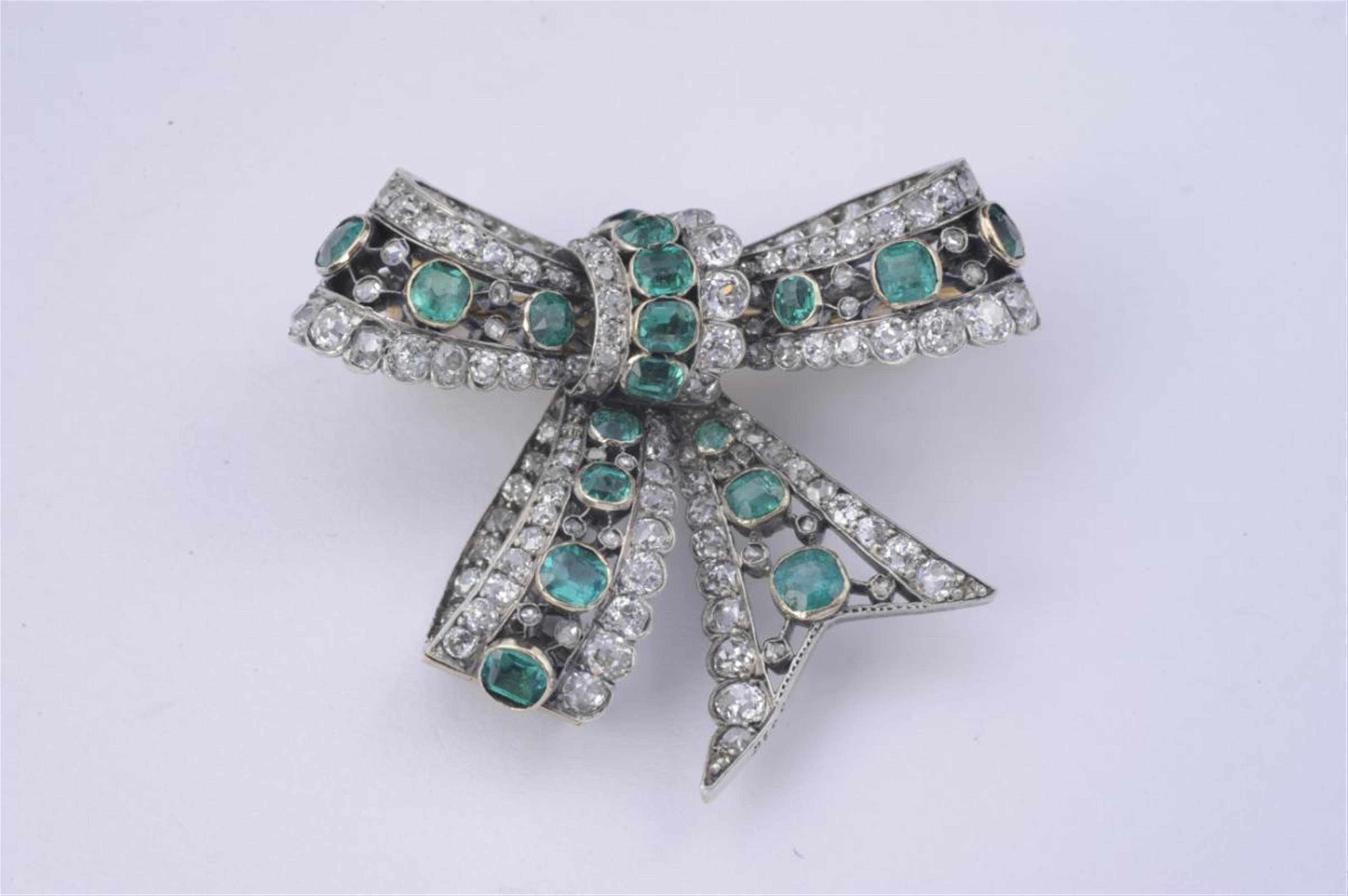 A French 18k gold, red gold, silver and emerald brooch formed as a bow. - image-1
