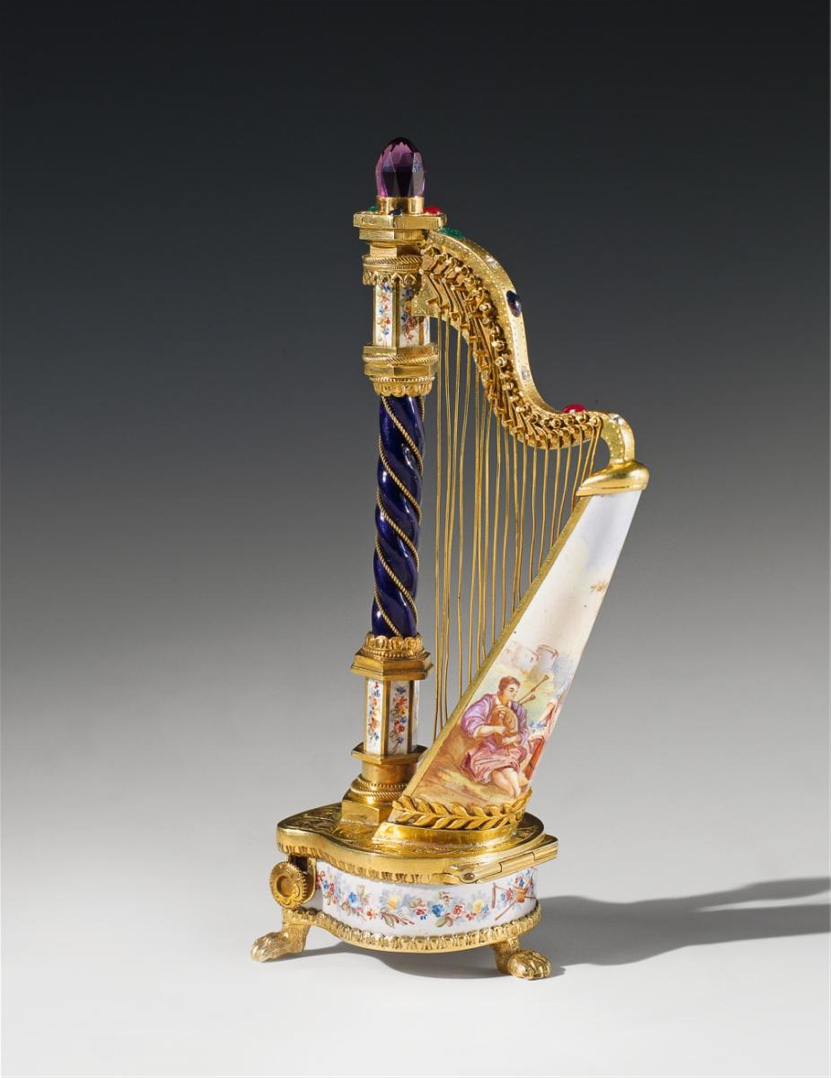 A small Viennese silver-gilt musical box formed as a harp. - image-1
