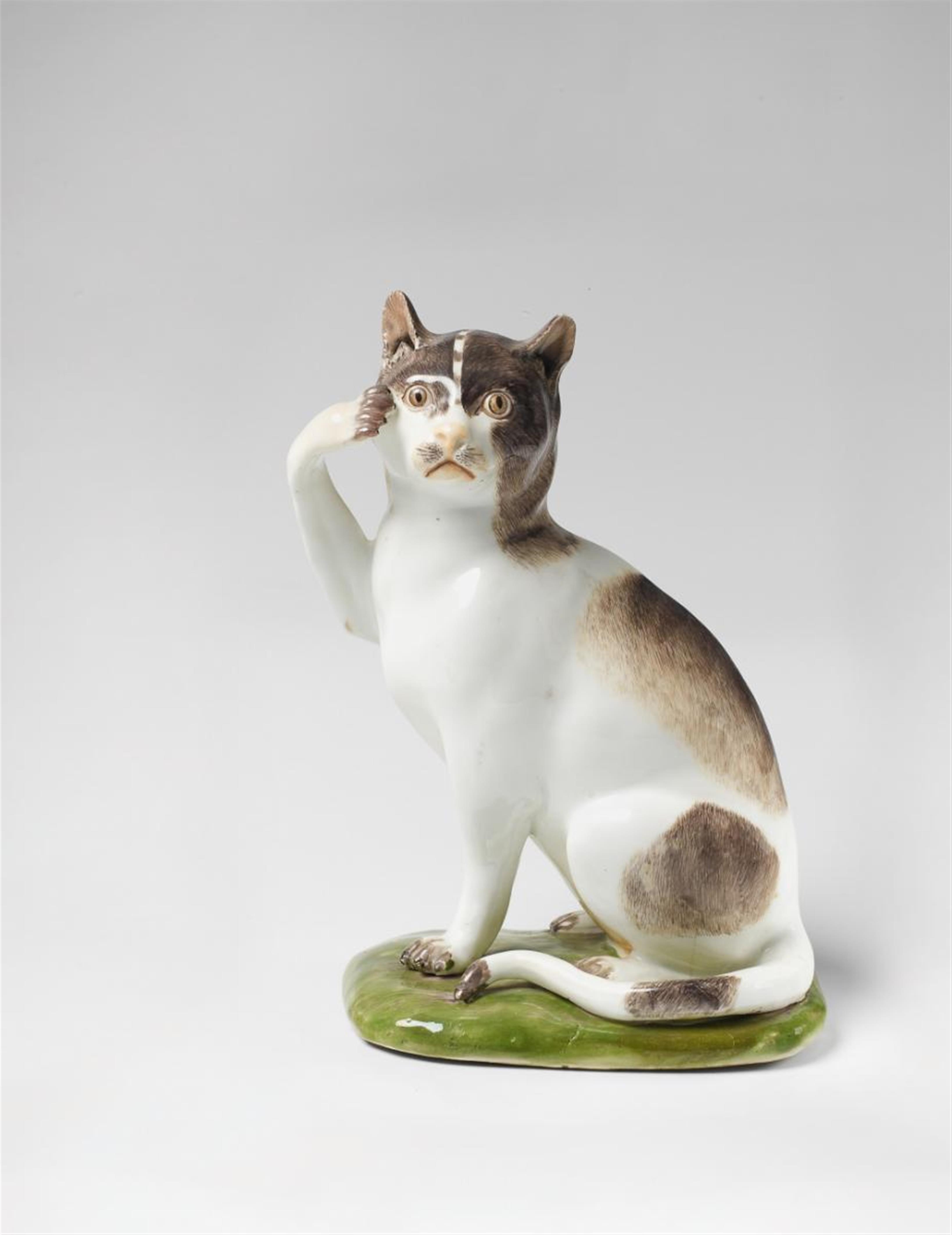 A naturalistically painted Meissen figure of a cat on an earth mound base. - image-1
