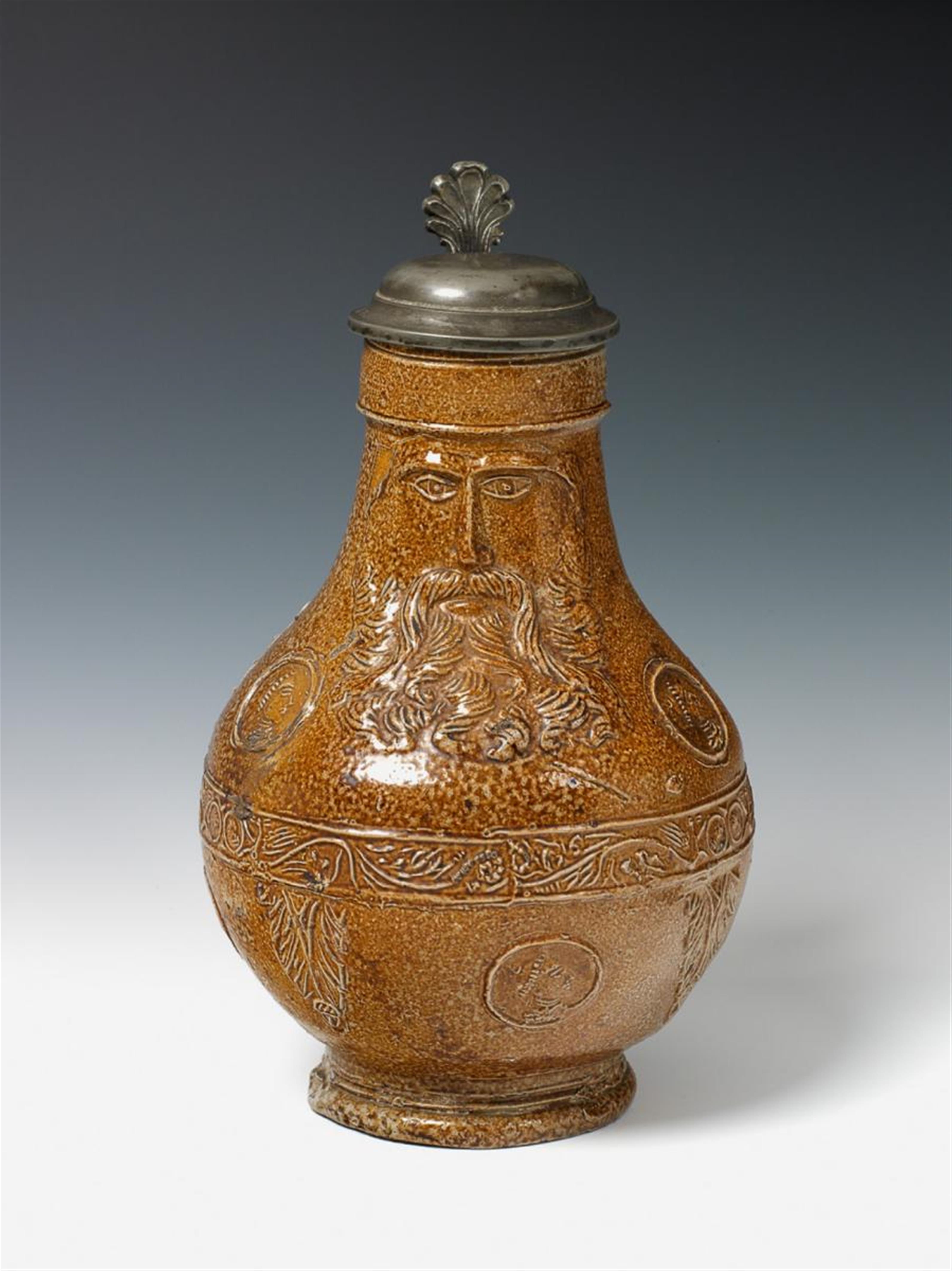 A brown, salt-glazed stoneware bellarmine tankard. - image-1