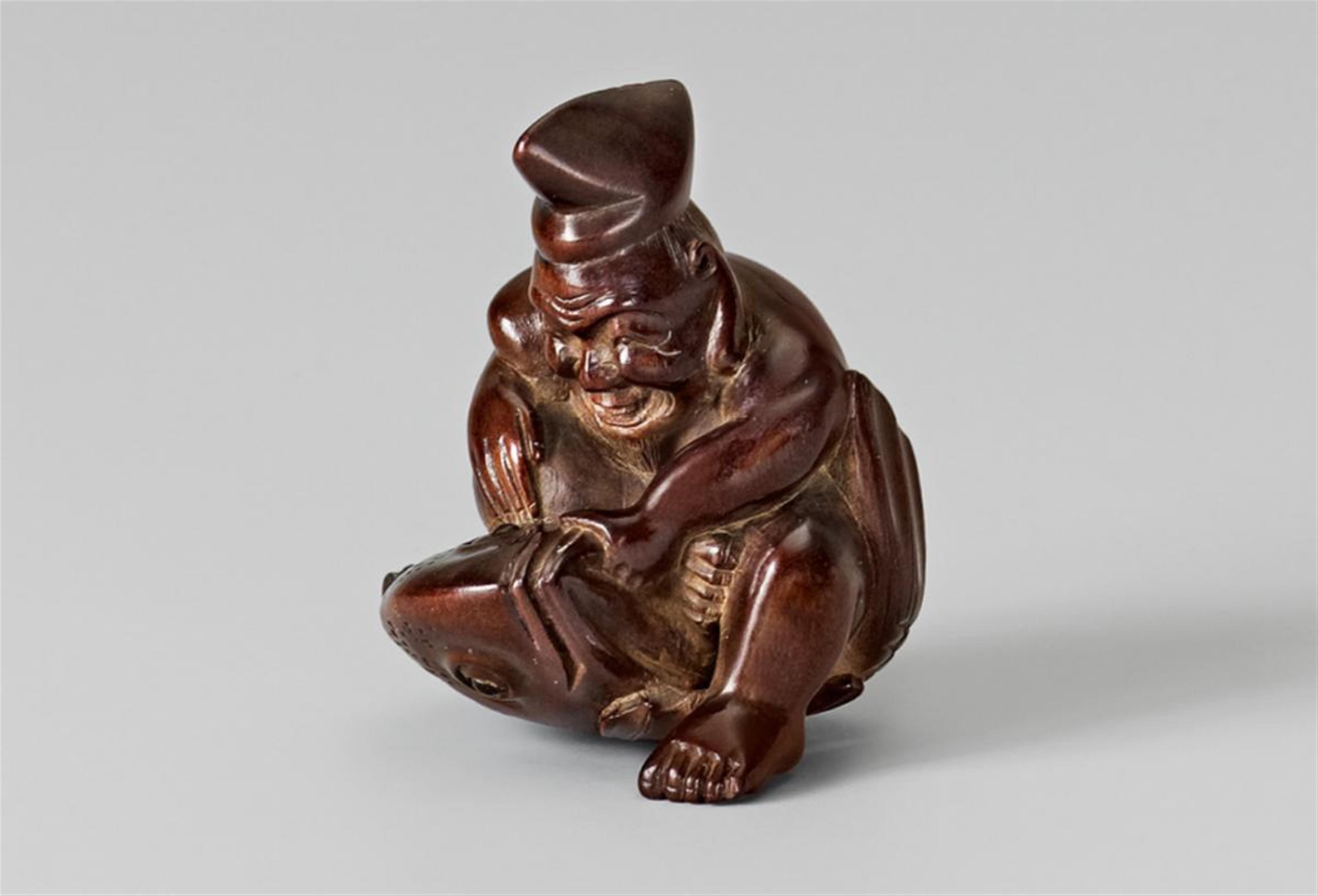 A wood netsuke of a friendly Ebisu with a sea bream, by Issai. Second half 19th century - image-1