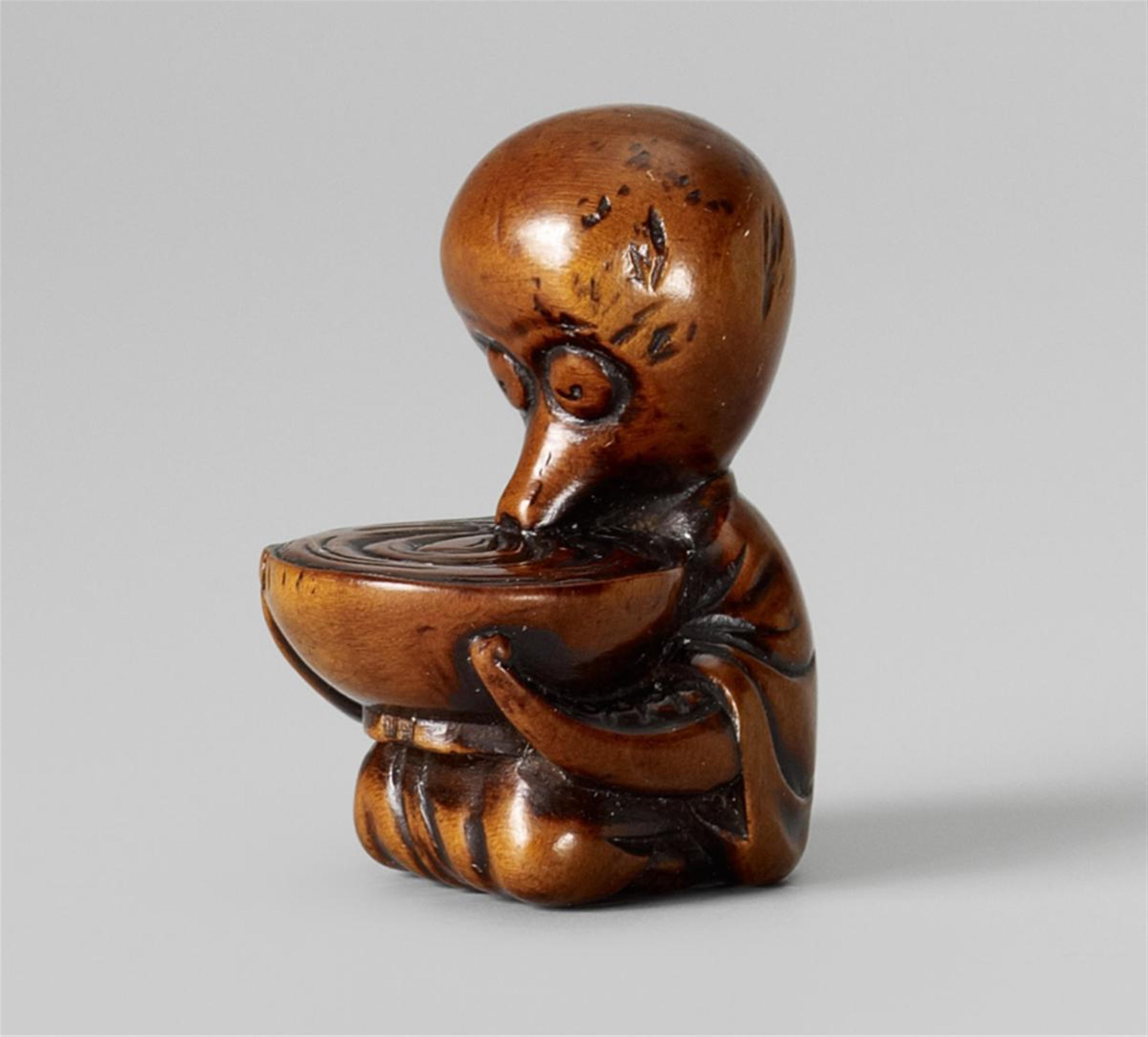 A boxwood netsuke of an octopus with a huge sake cup. Mid-19th century - image-1