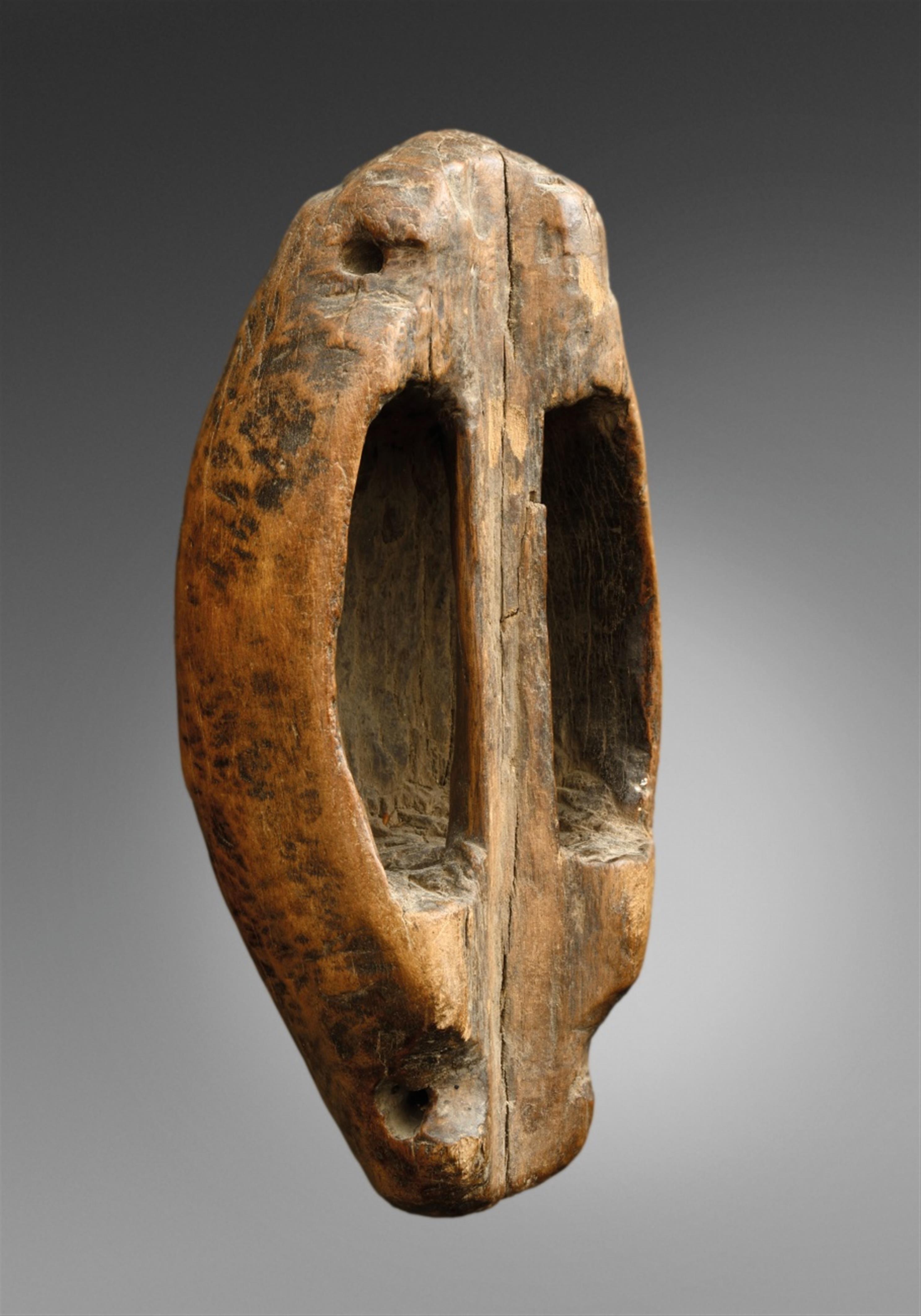 TWO SUDAN SHIELDS A Shilluk shield of cylindrical form tapering at each end, covered in hide, carved grip; and a Dinka shield, of ovoid form with carved grip, dark patina. - image-2