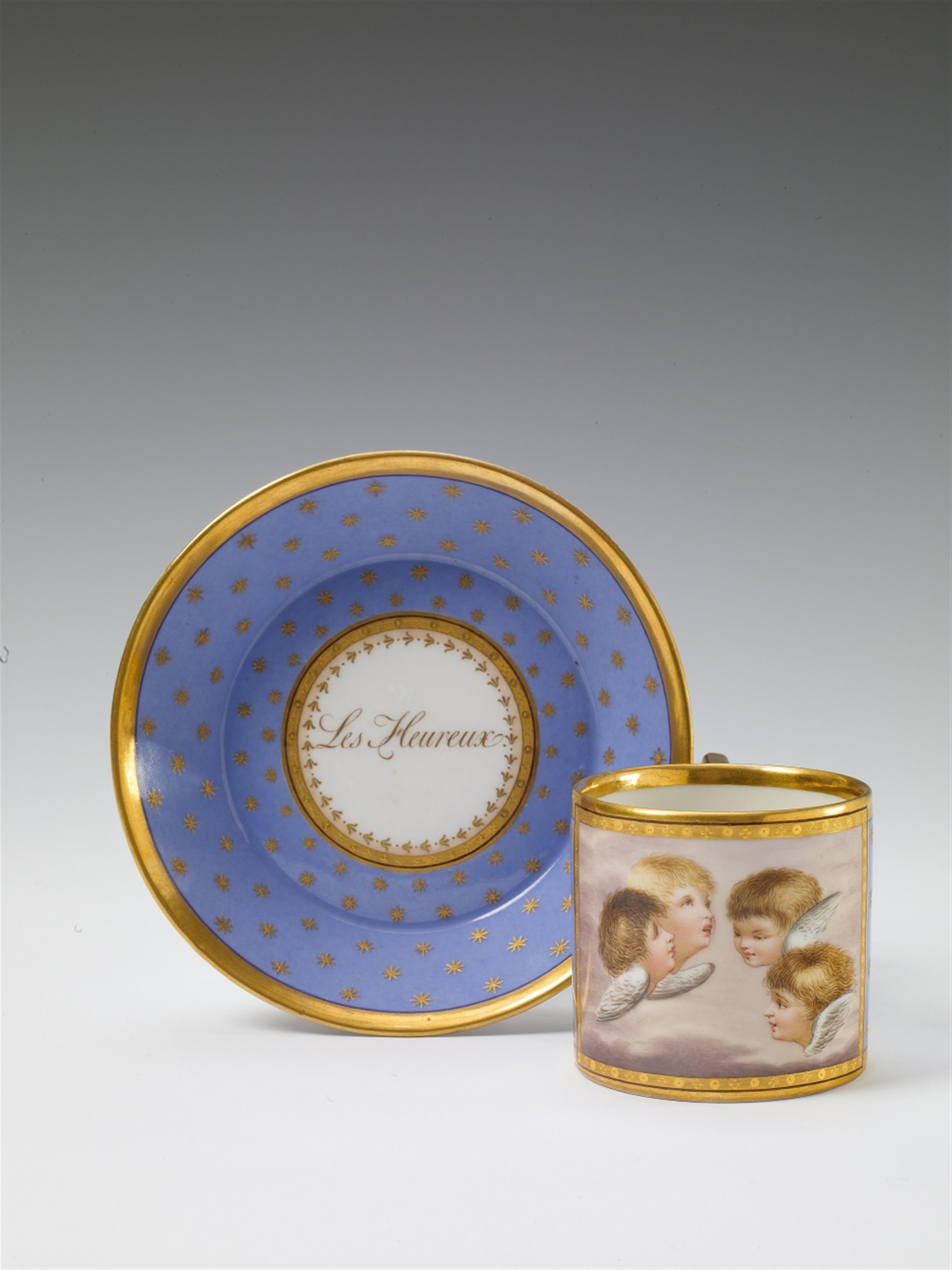 A Berlin KPM porcelain cup and saucer decorated with putti amongst clouds. - image-1