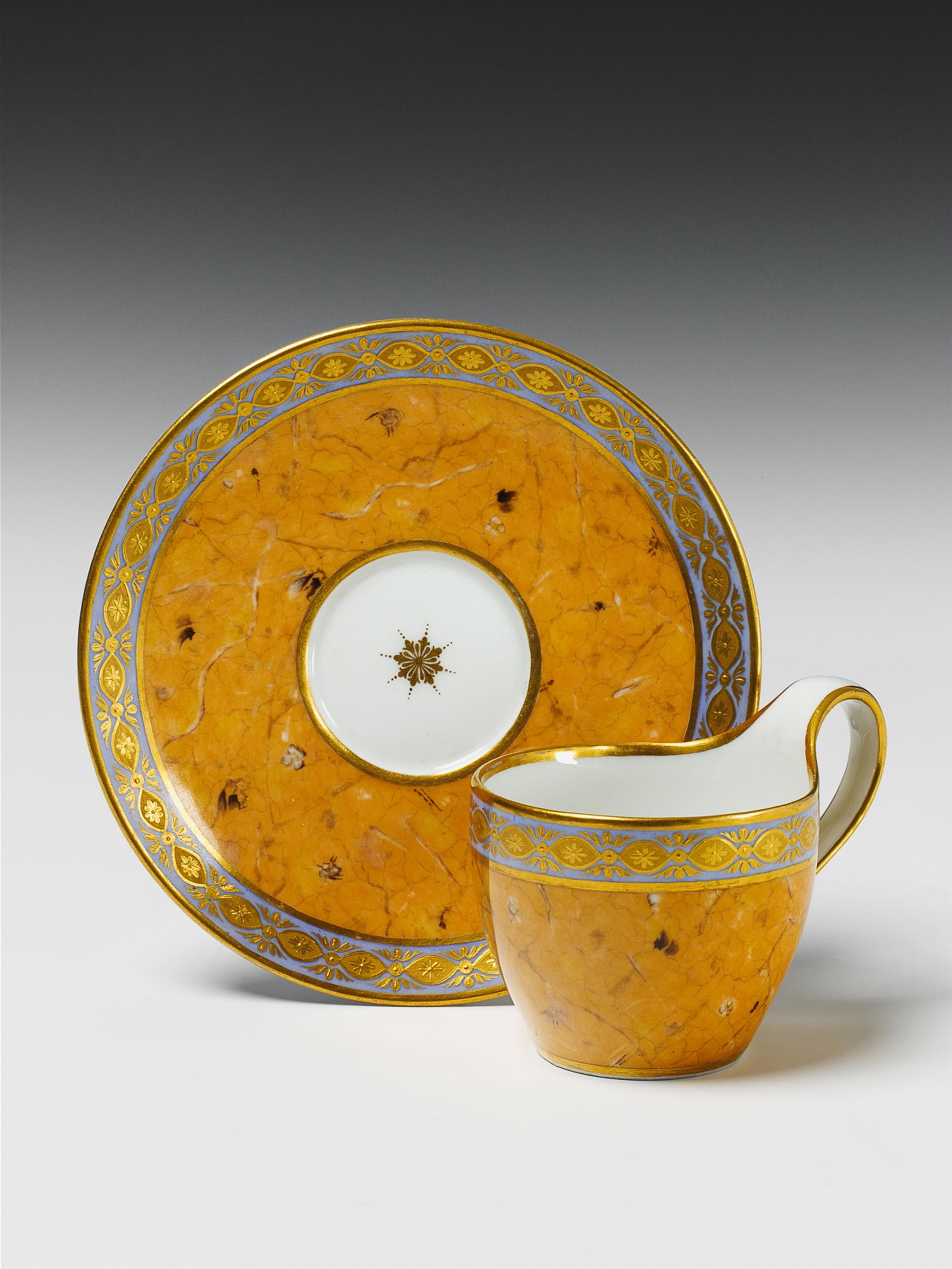A Berlin KPM porcelain cup and saucer with imitation marble and gilt relief decor. - image-1