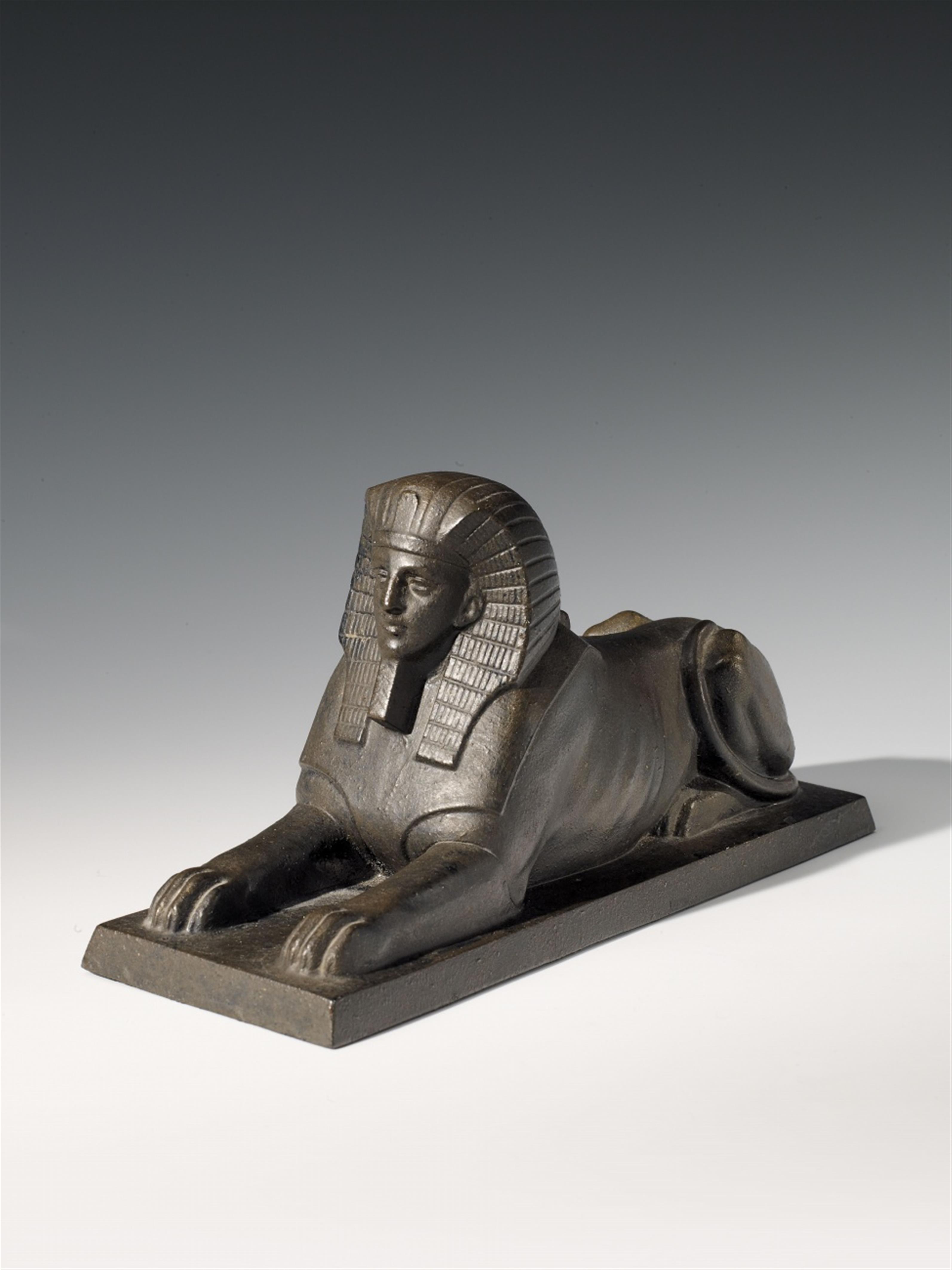A Hanau cast iron figure of a recumbent Sphinx. - image-1