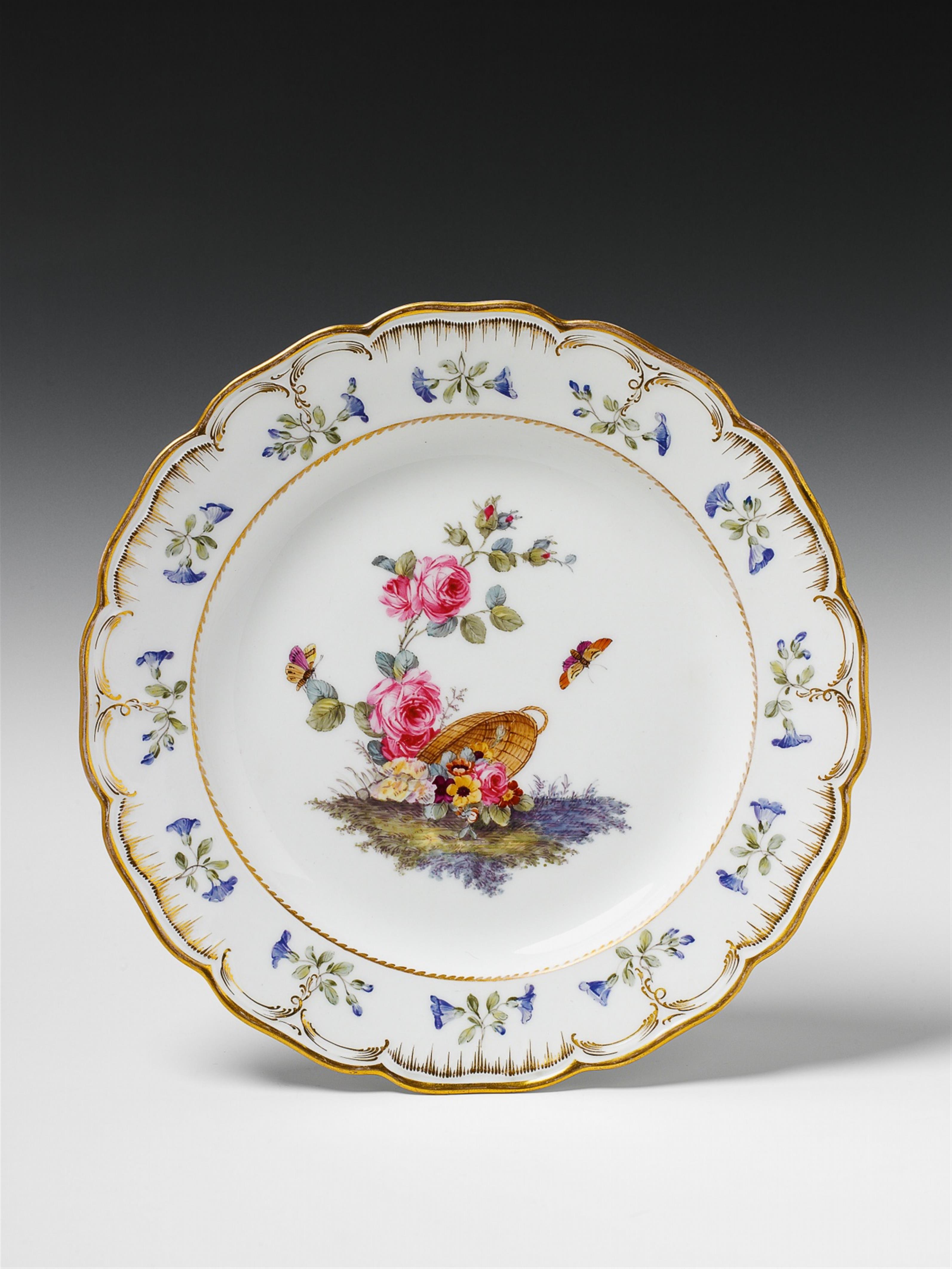 A Berlin KPM porcelain dinner plate from the service with the toppled flower basket. - image-1