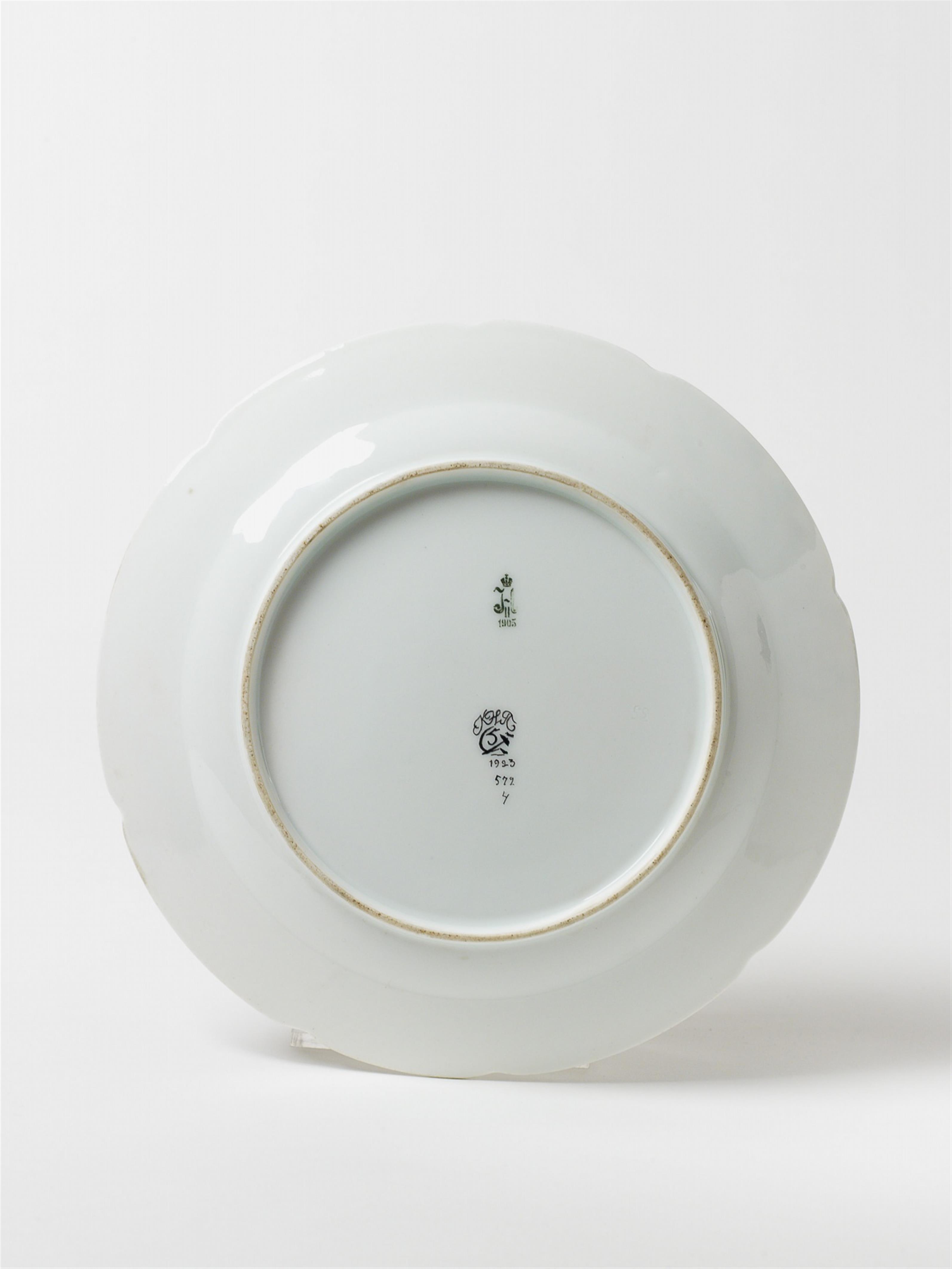 A shaped porcelain plate with stylised enamel decor. - image-2