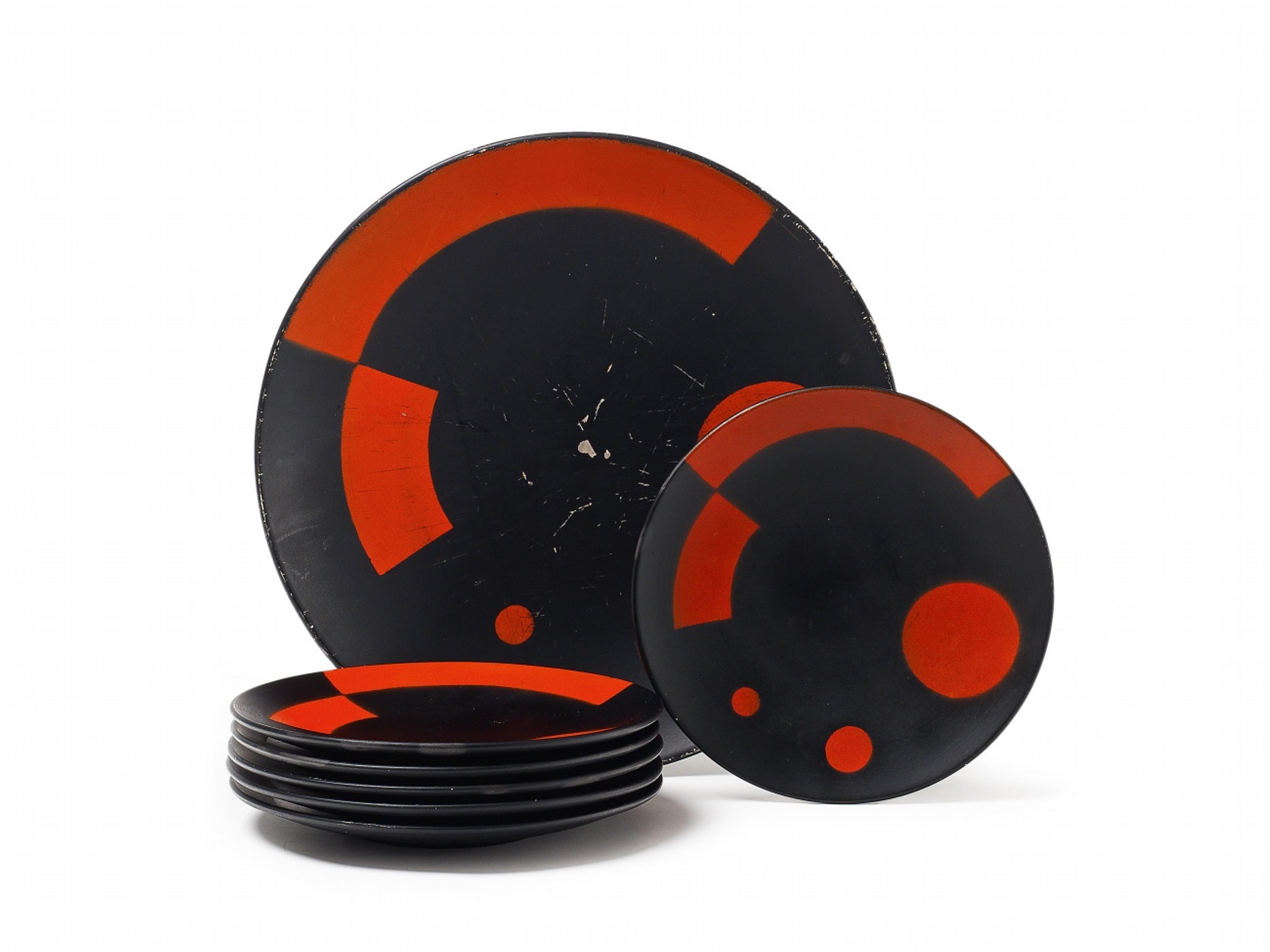 Six Suprematist porcelain plates and a platter with red and black geometric decor. - image-1