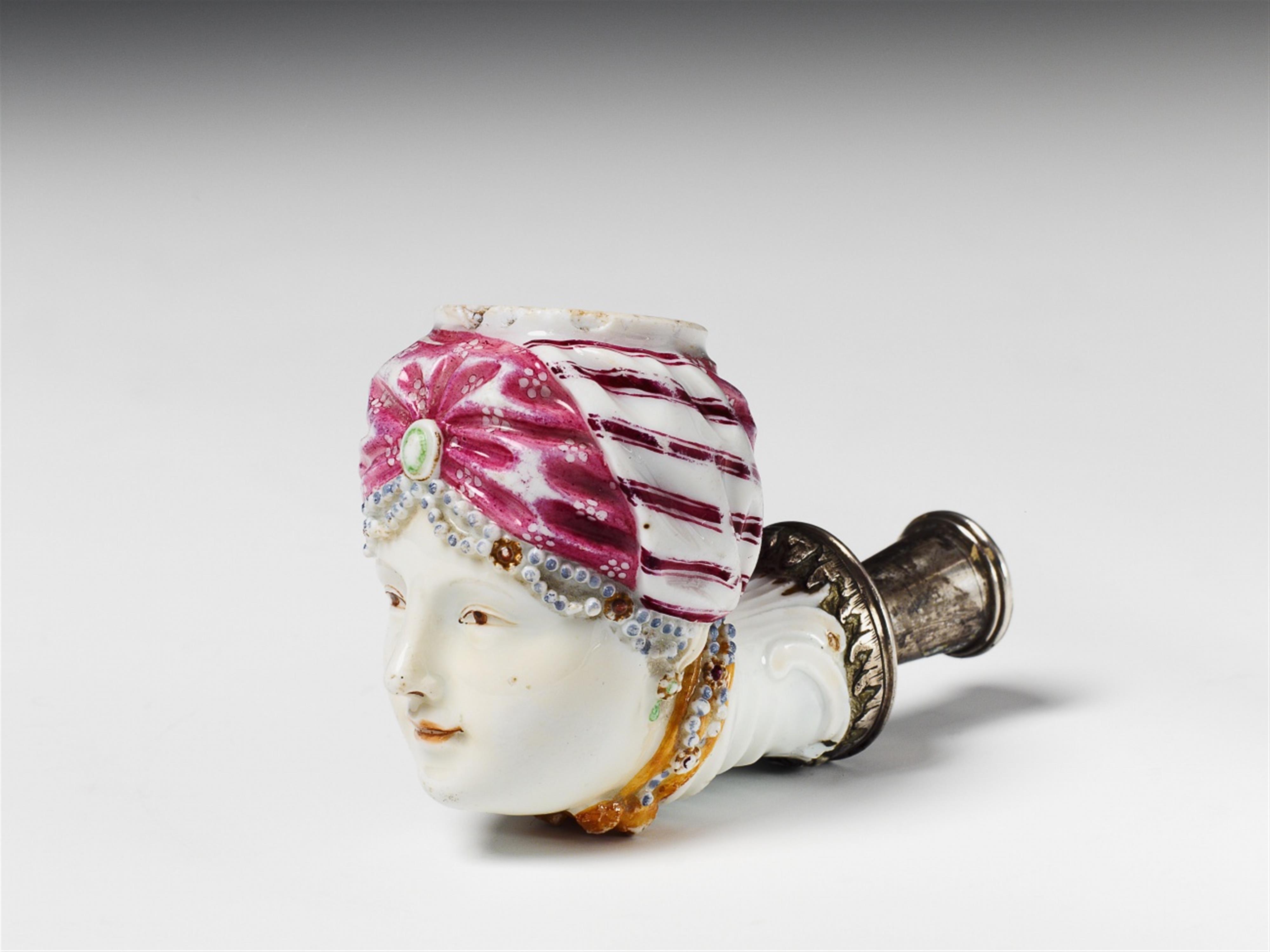 A Berlin KPM silver-mounted porcelain pipe bowl formed as a Turkish lady. - image-1