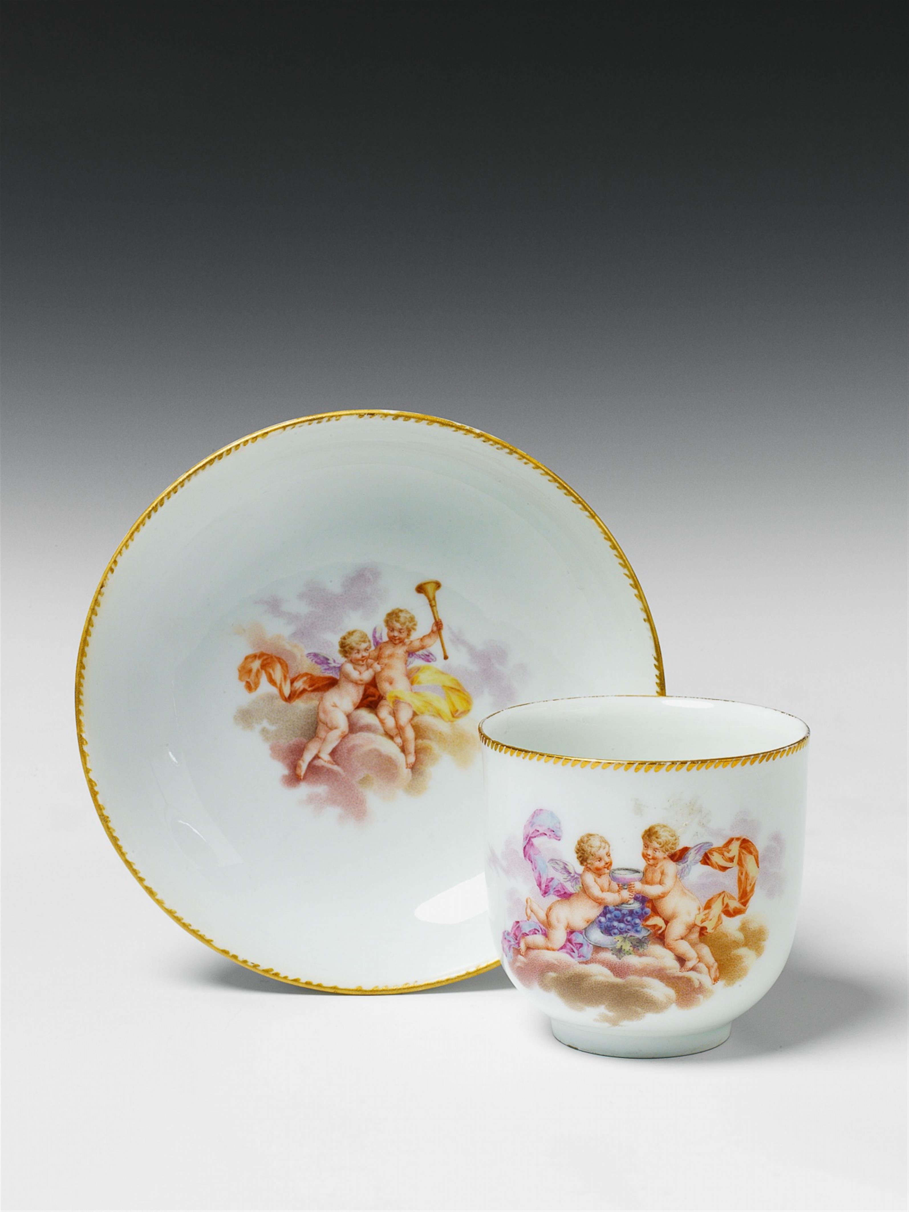 A Berlin KPM porcelain cup and saucer decorated with flying putti. - image-1