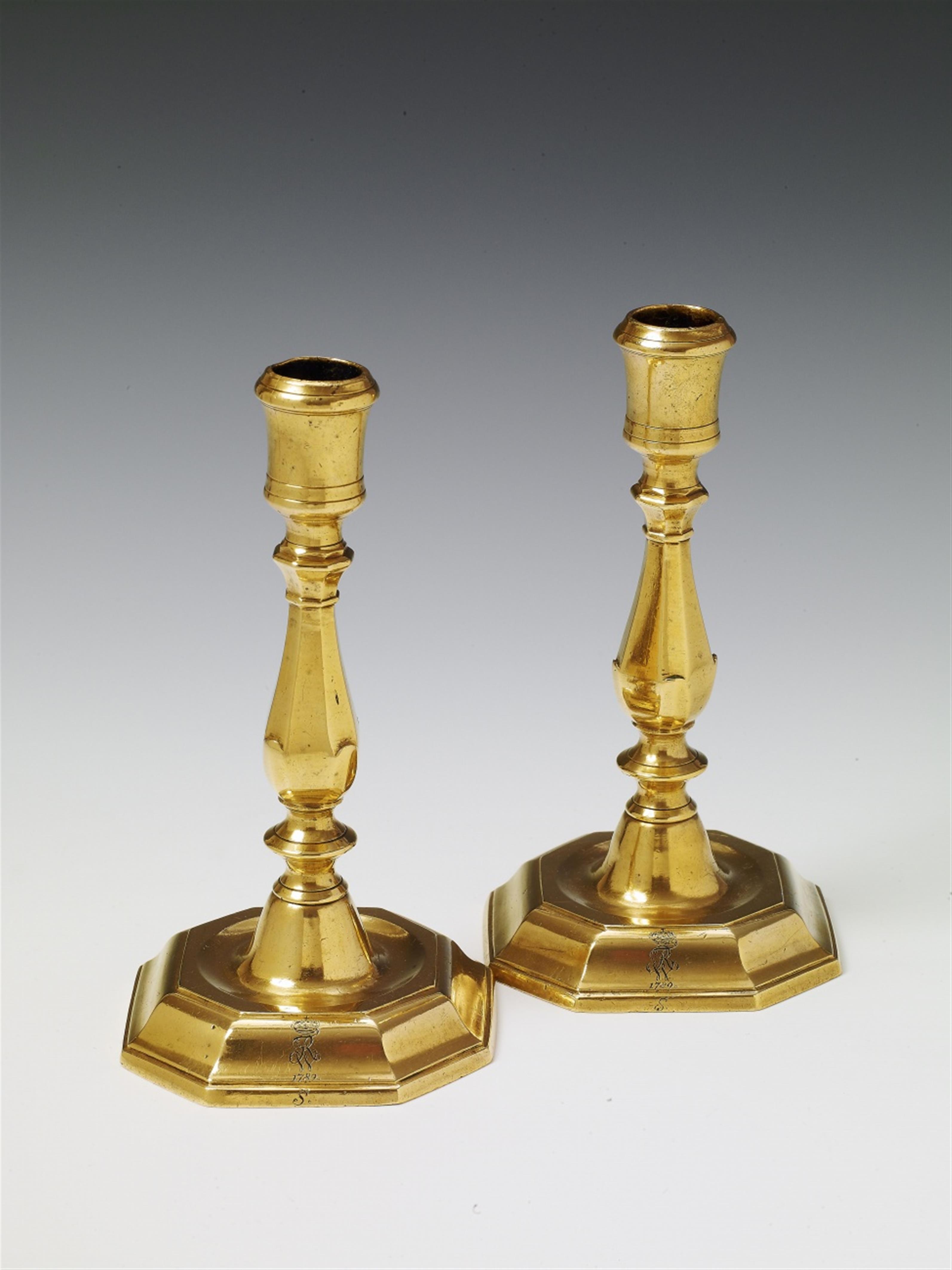 A pair of Baroque brass candlesticks. - image-1