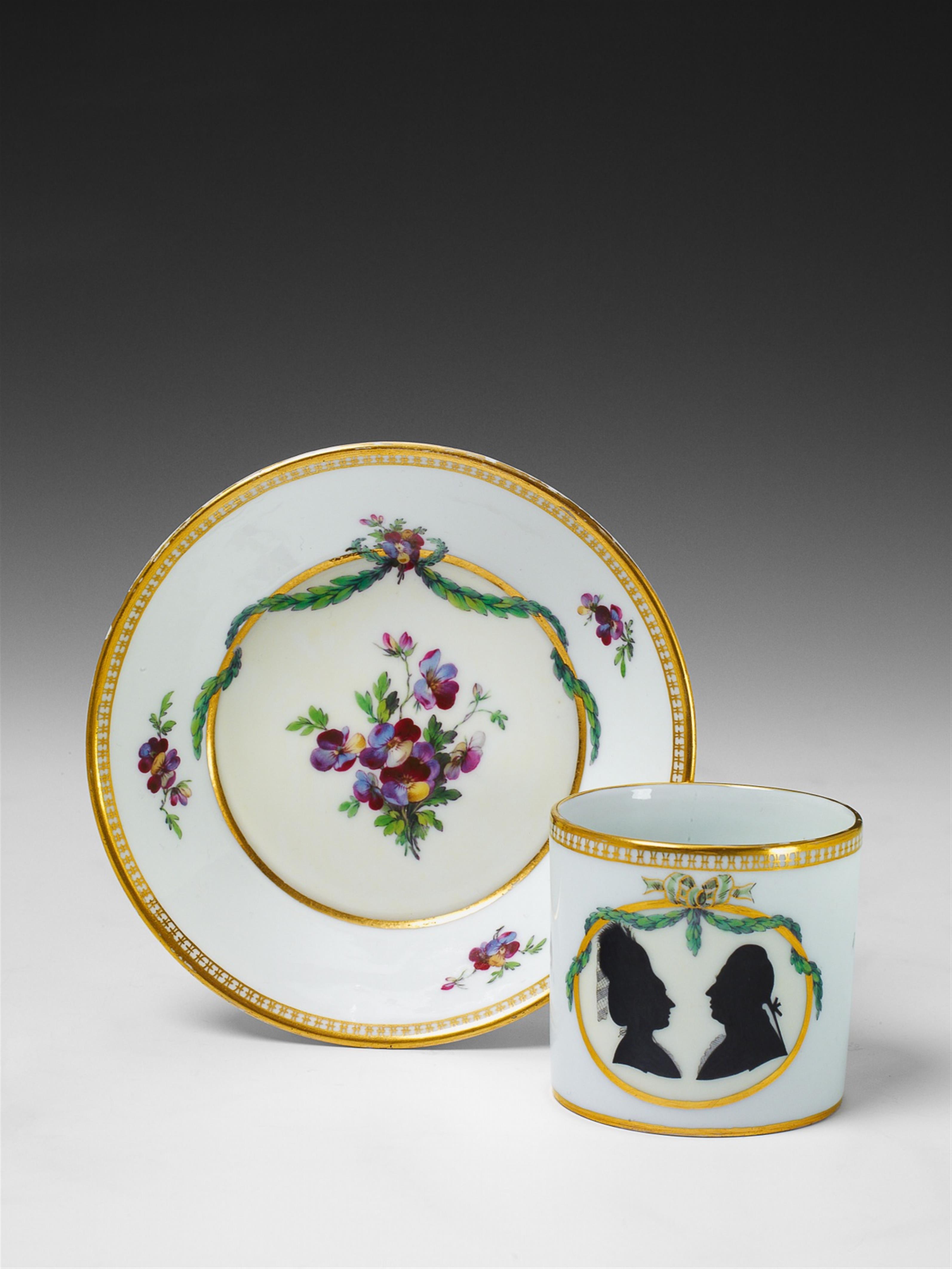 A Berlin KPM porcelain cup and saucer with a silhouetted couple - image-1