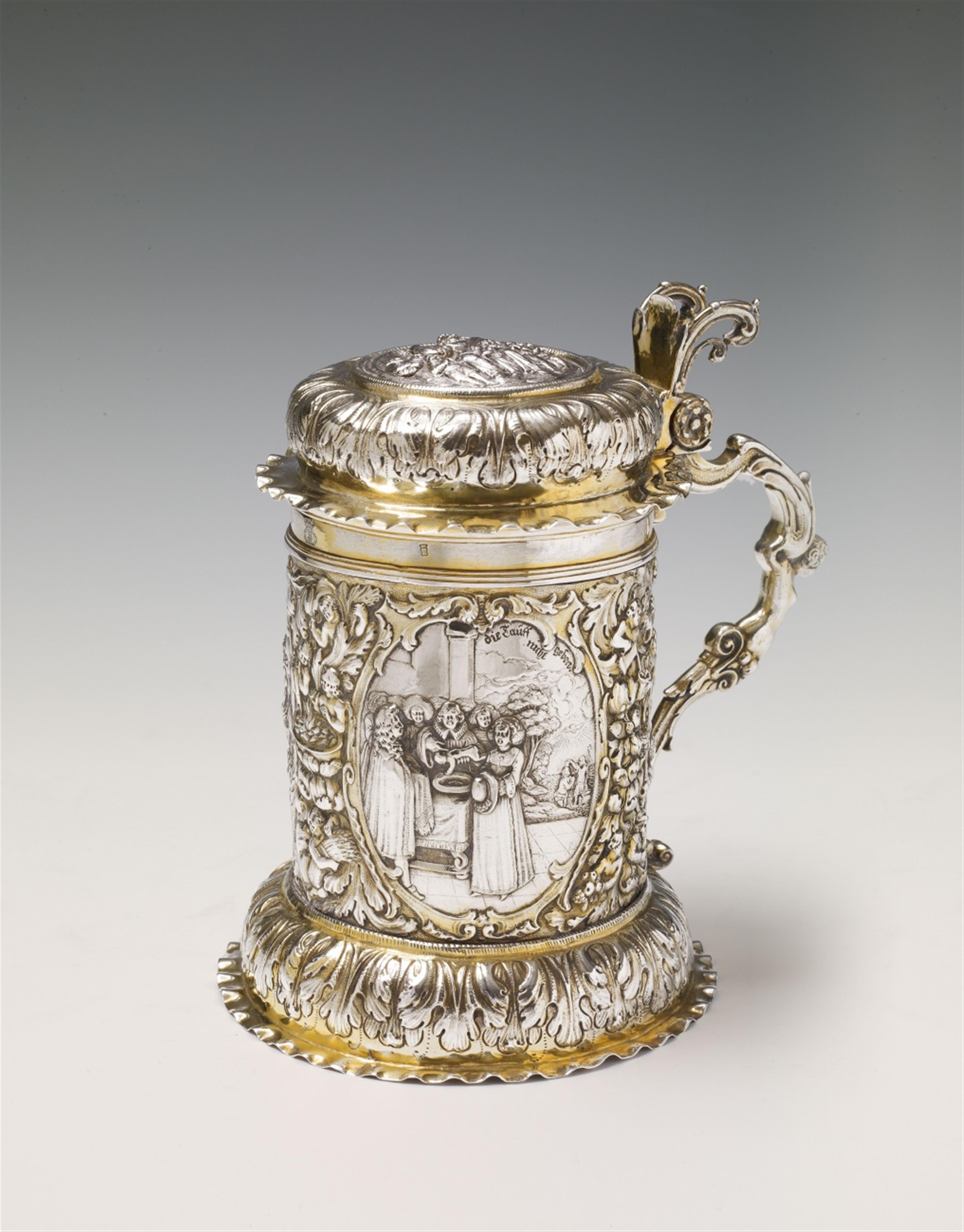 A Nuremberg silver gilt tankard. Of cylindrical form on a bulbous base, the rim moulded and the volute handle decorated with a female herm. The body engraved and embossed with biblical scenes in three oval reserves: 1. The creation of Eve, 2. The annuncia - image-3