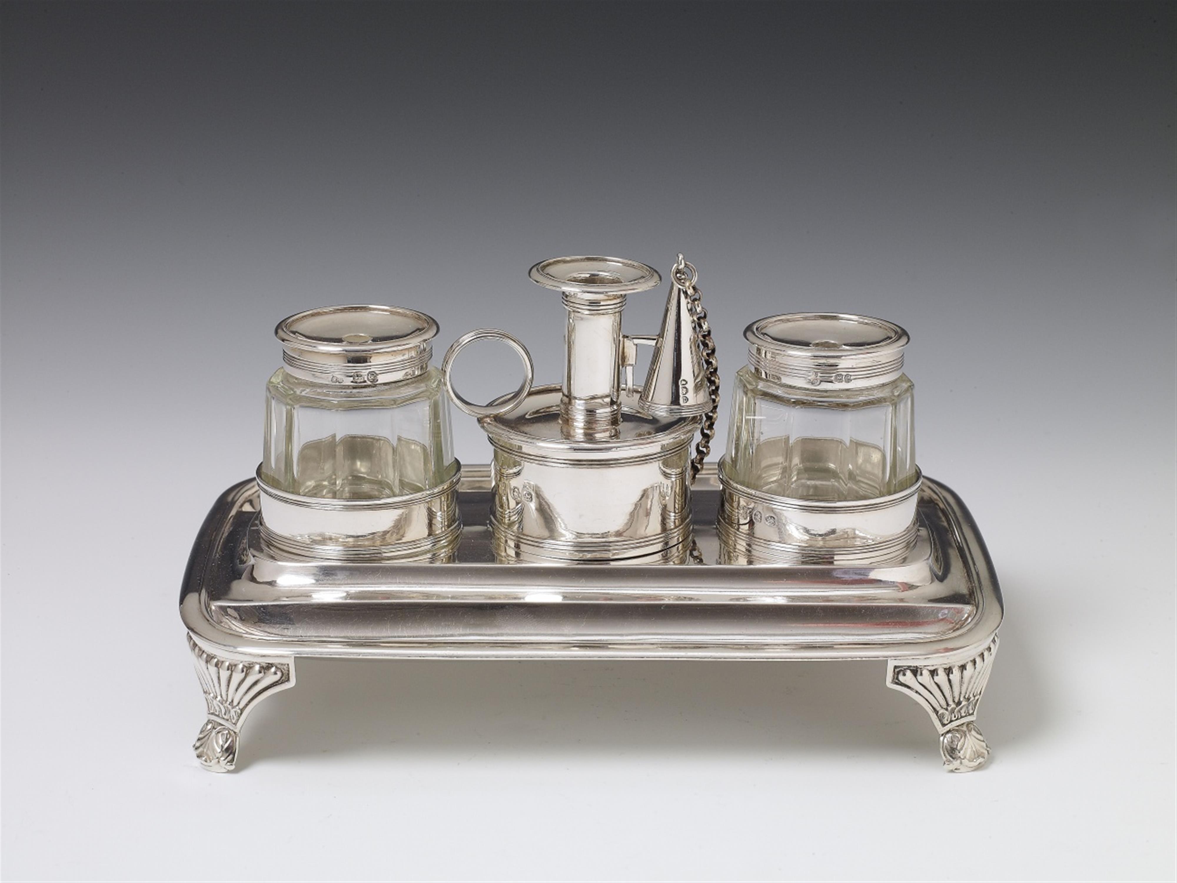 A London silver George III writing set. Comprising tray with cylindrical holders for two glass inkwells, a small taperstick and candle snuffer. Marks of Rebecca Emes and Edward Barnard, 1820. - image-1