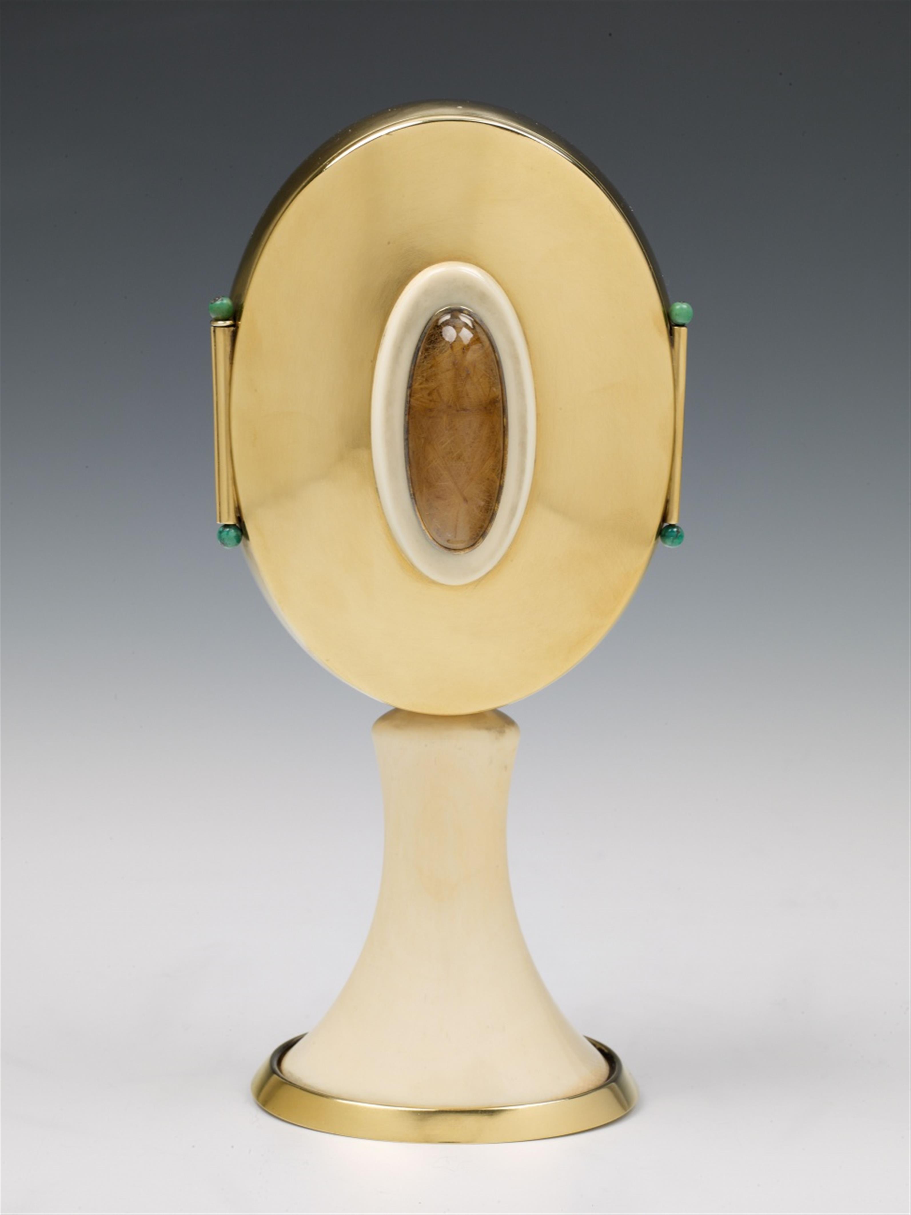 A Cologne silver gilt closed monstrance. The base and shaft of polished ivory, the sides set with small turquoise spheres, the front and back each set with a large rock crystal cabochon. Marks of Wilhelm Nagel, ca. 1950. - image-1