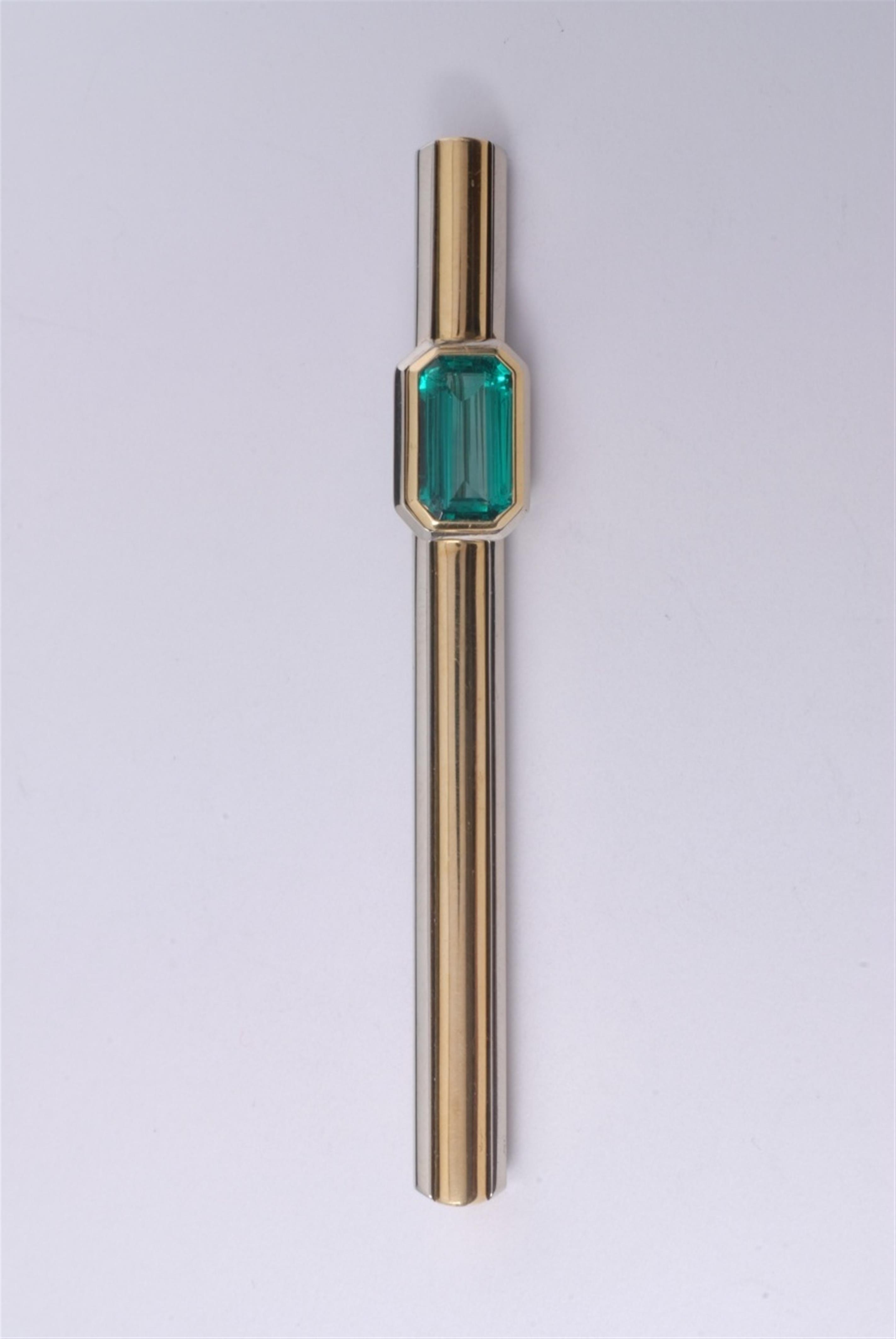 An 18k yellow gold, 14k white gold and emerald brooch. - image-1