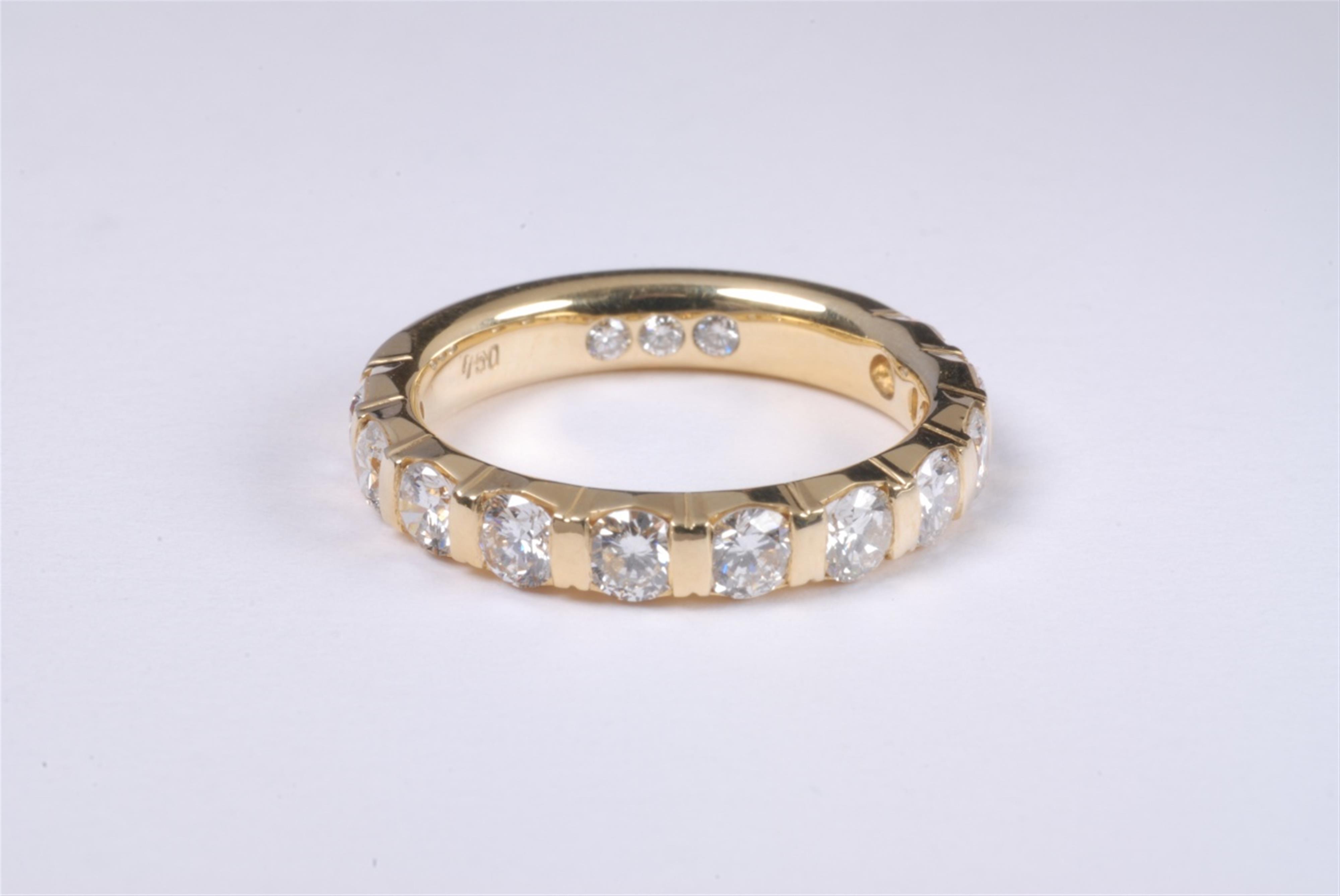 An 18k gold and diamond eternity ring - image-1
