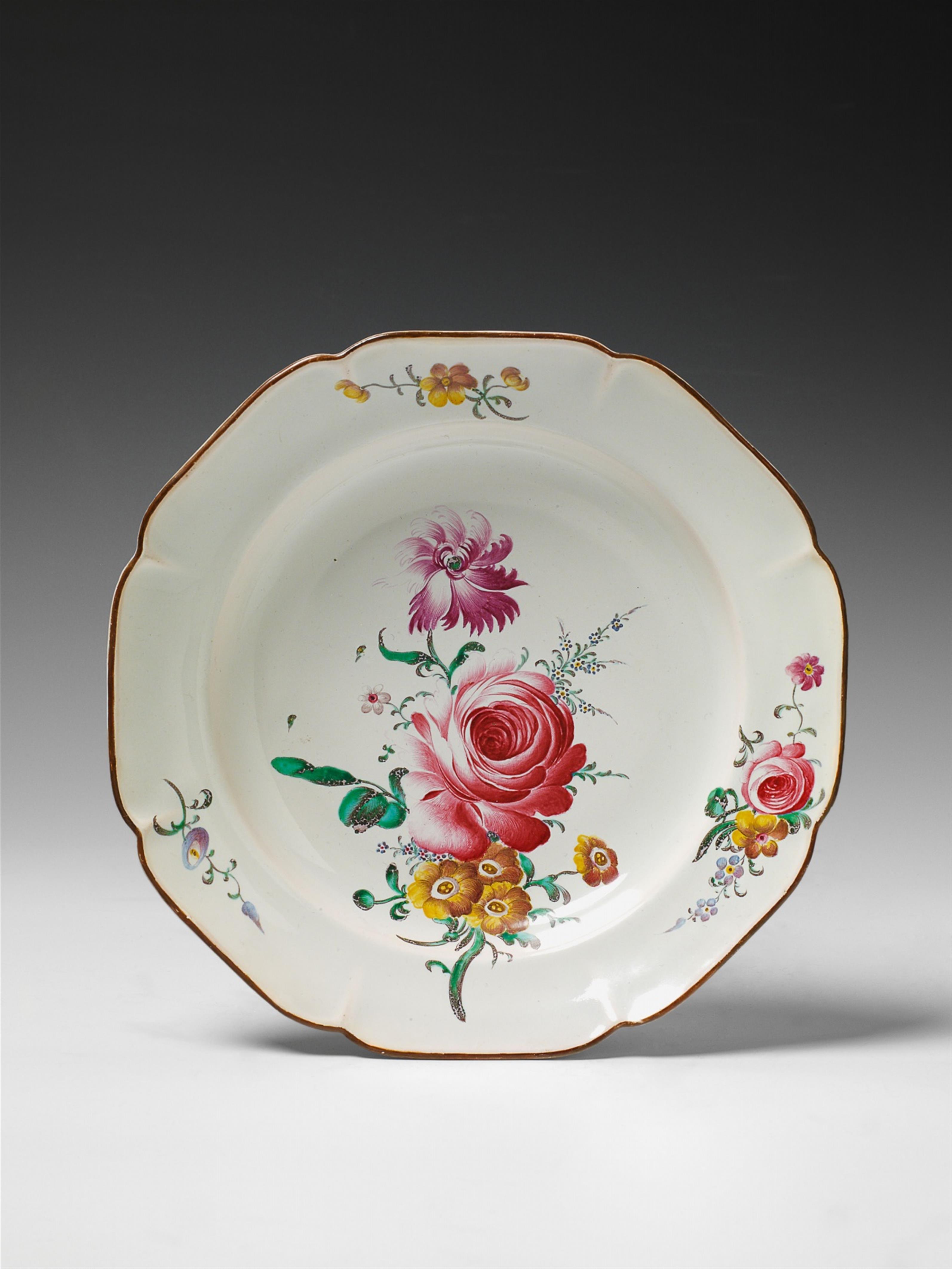 An octagonal Strasbourg faience plate with overglaze floral decor. - image-1