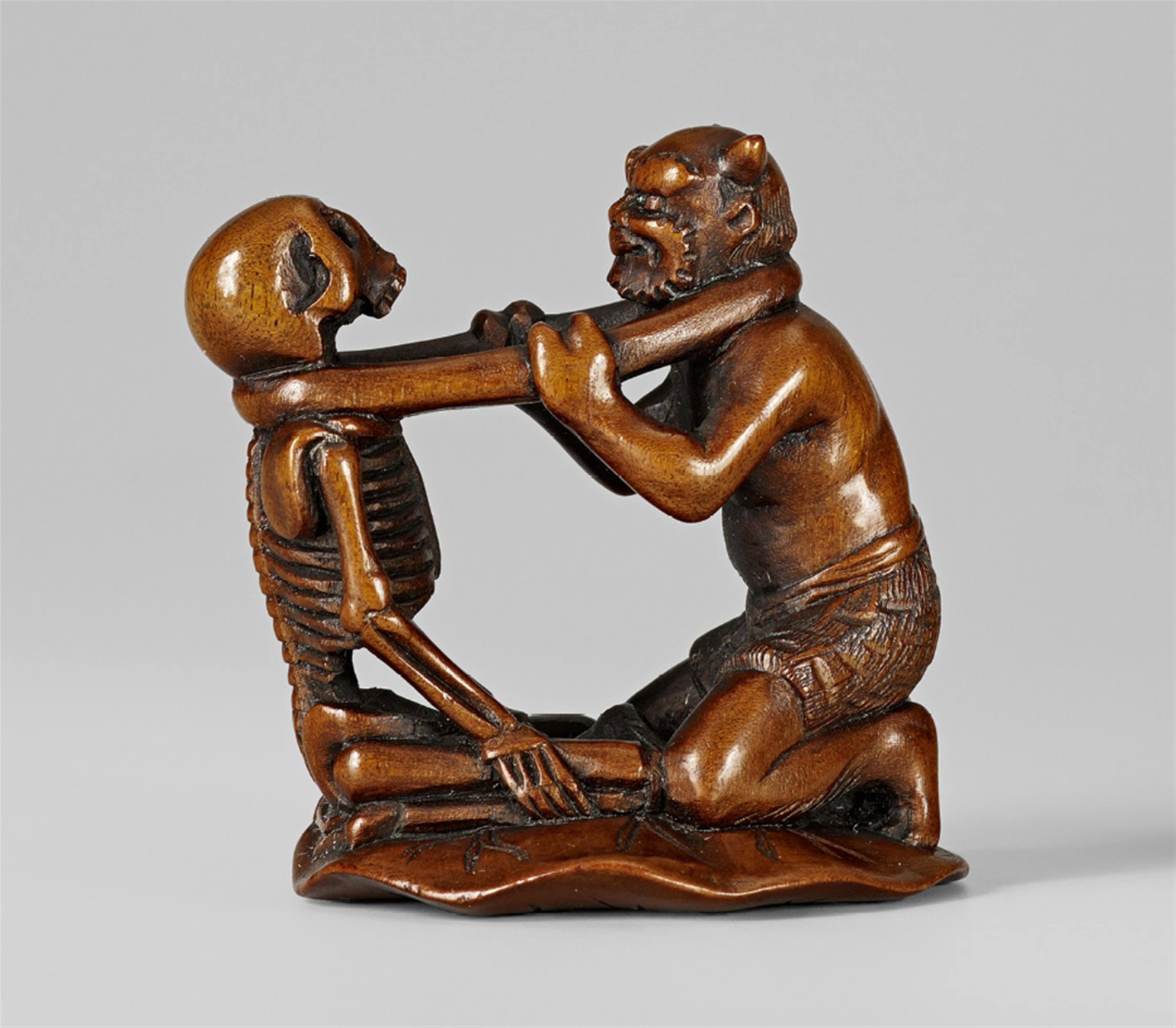 A boxwood netsuke of an oni and a skeleton. Late 19th century - image-1
