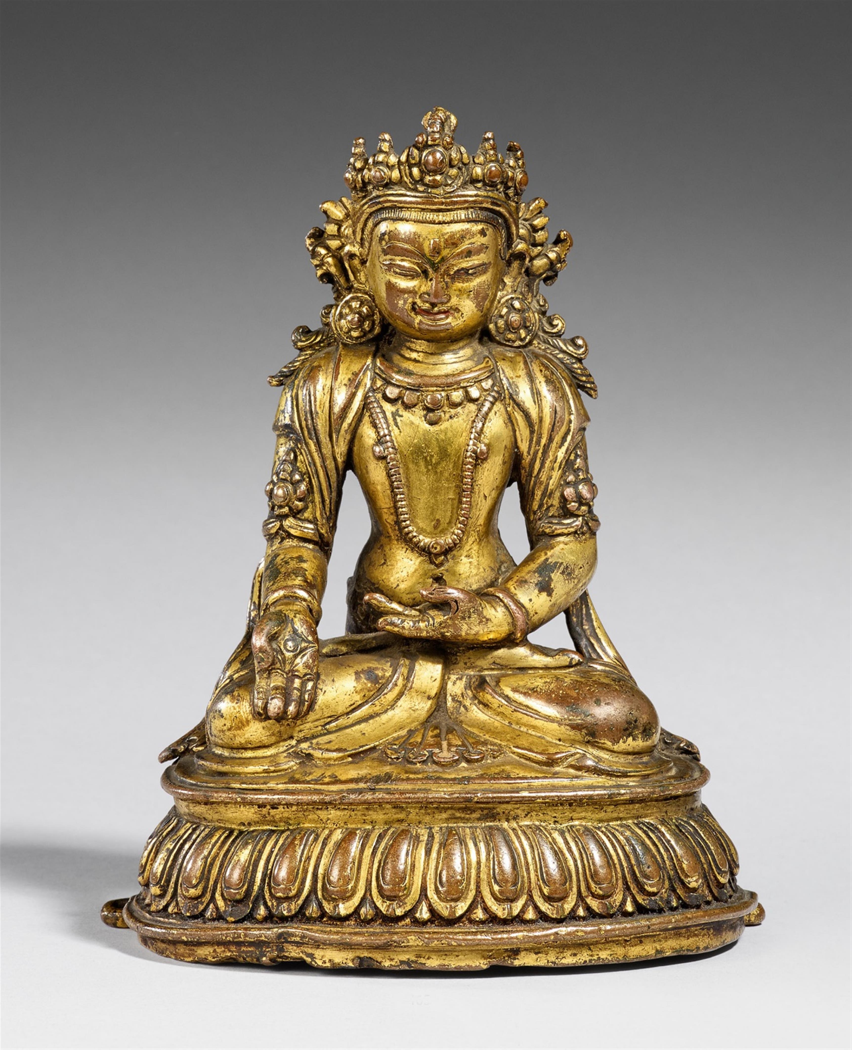 A Tibetan gilt copper figure of Buddha Ratnasambhava. 14./15th century - image-1