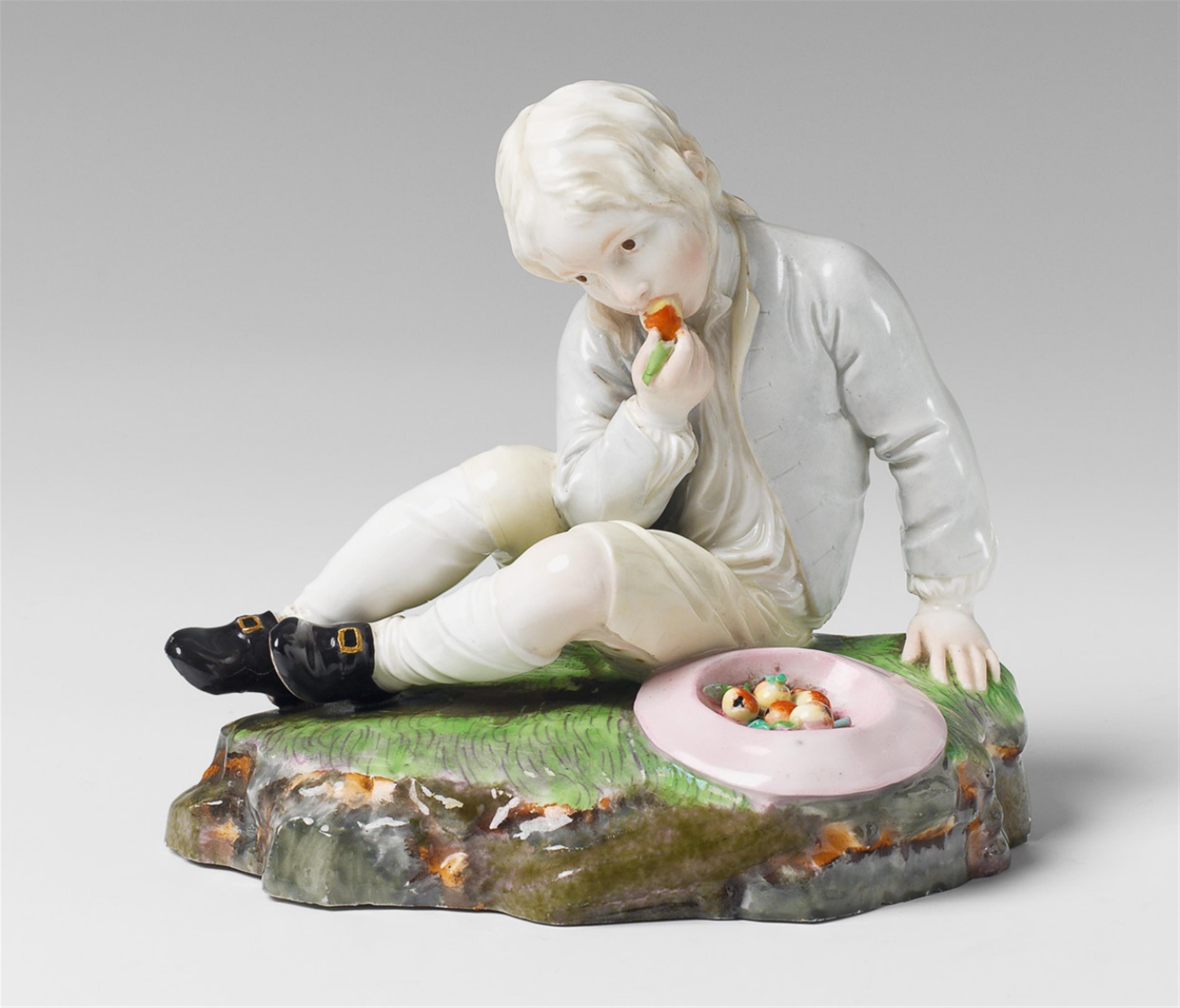 A Höchst porcelain figure of a boy eating a pear. - image-1