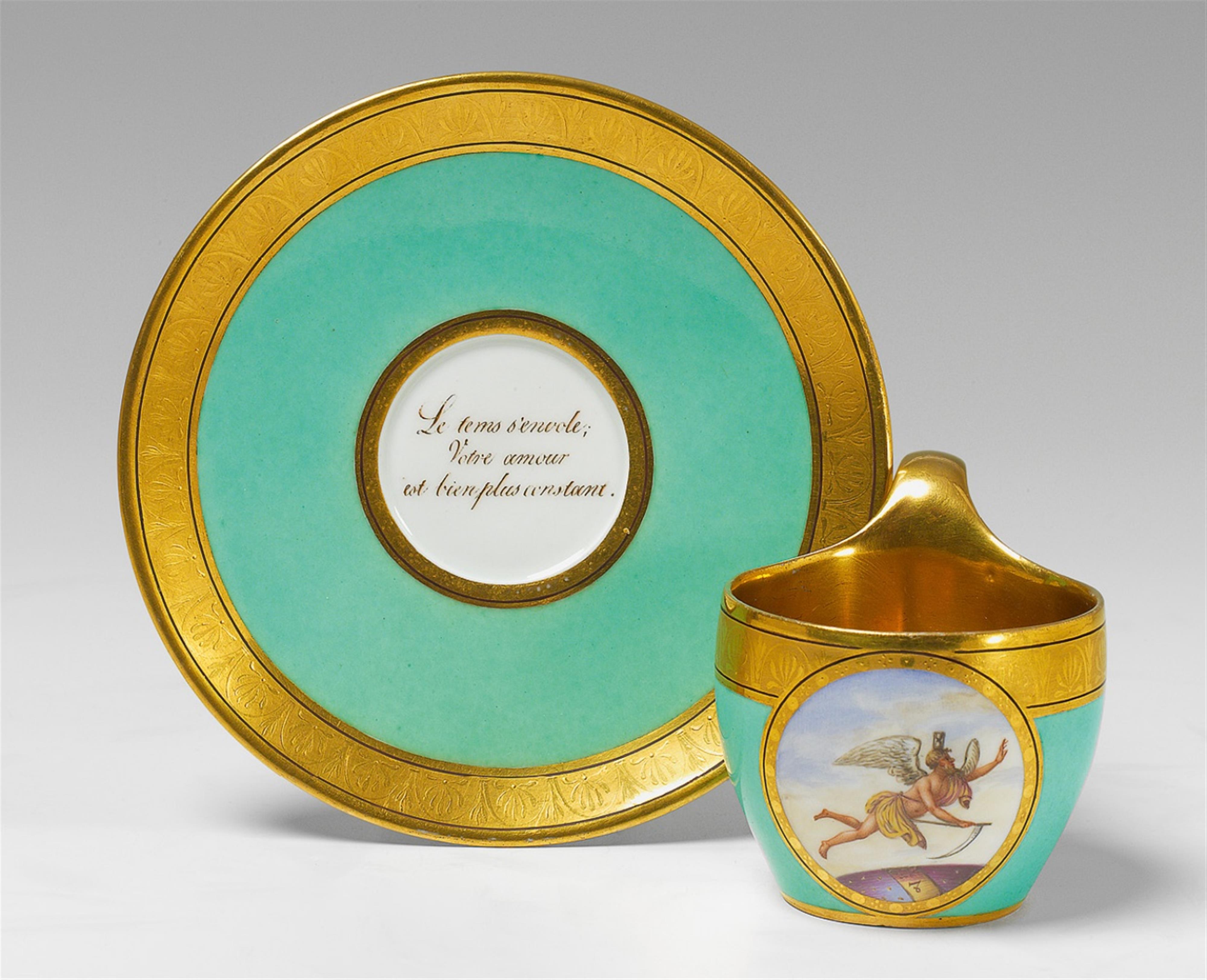 A Berlin KPM porcelain motto cup and saucer. - image-1