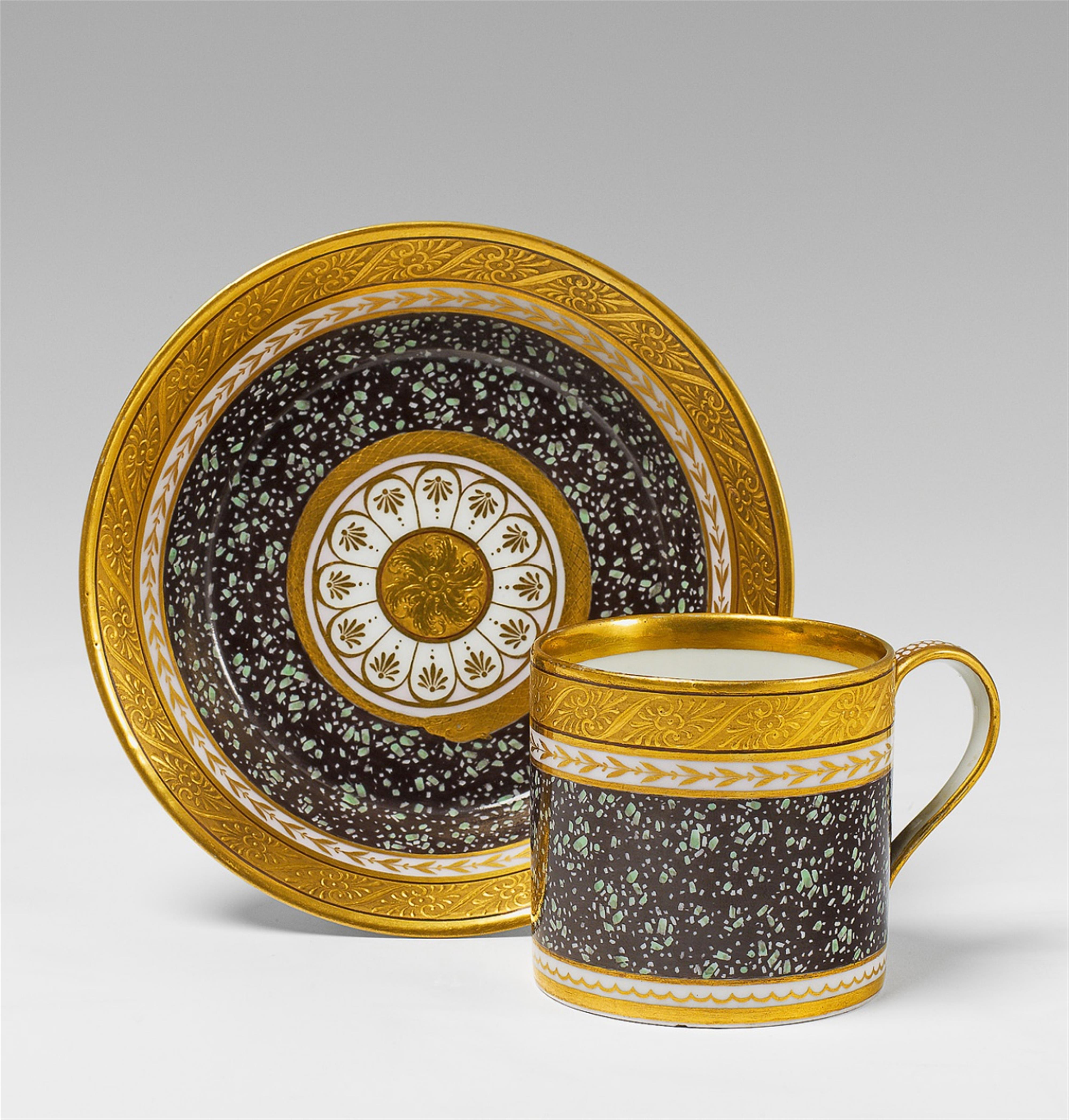 A Berlin KPM porcelain teacup and saucer with faux porphyry decor. - image-1